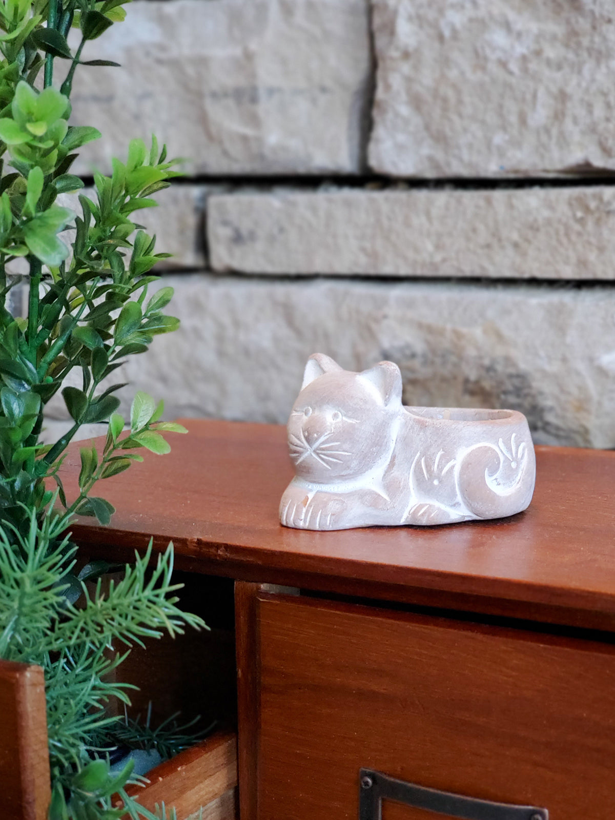 Handmade terracotta tea light candle holder shaped like a cat, showcasing natural color and unique design.