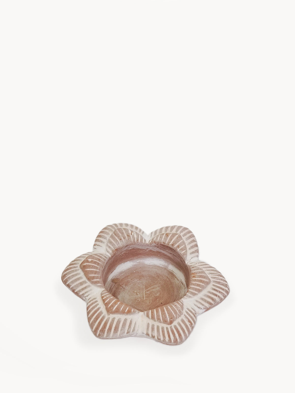 Handmade terracotta tea light candle holder in flower design, showcasing natural clay texture and unique craftsmanship.