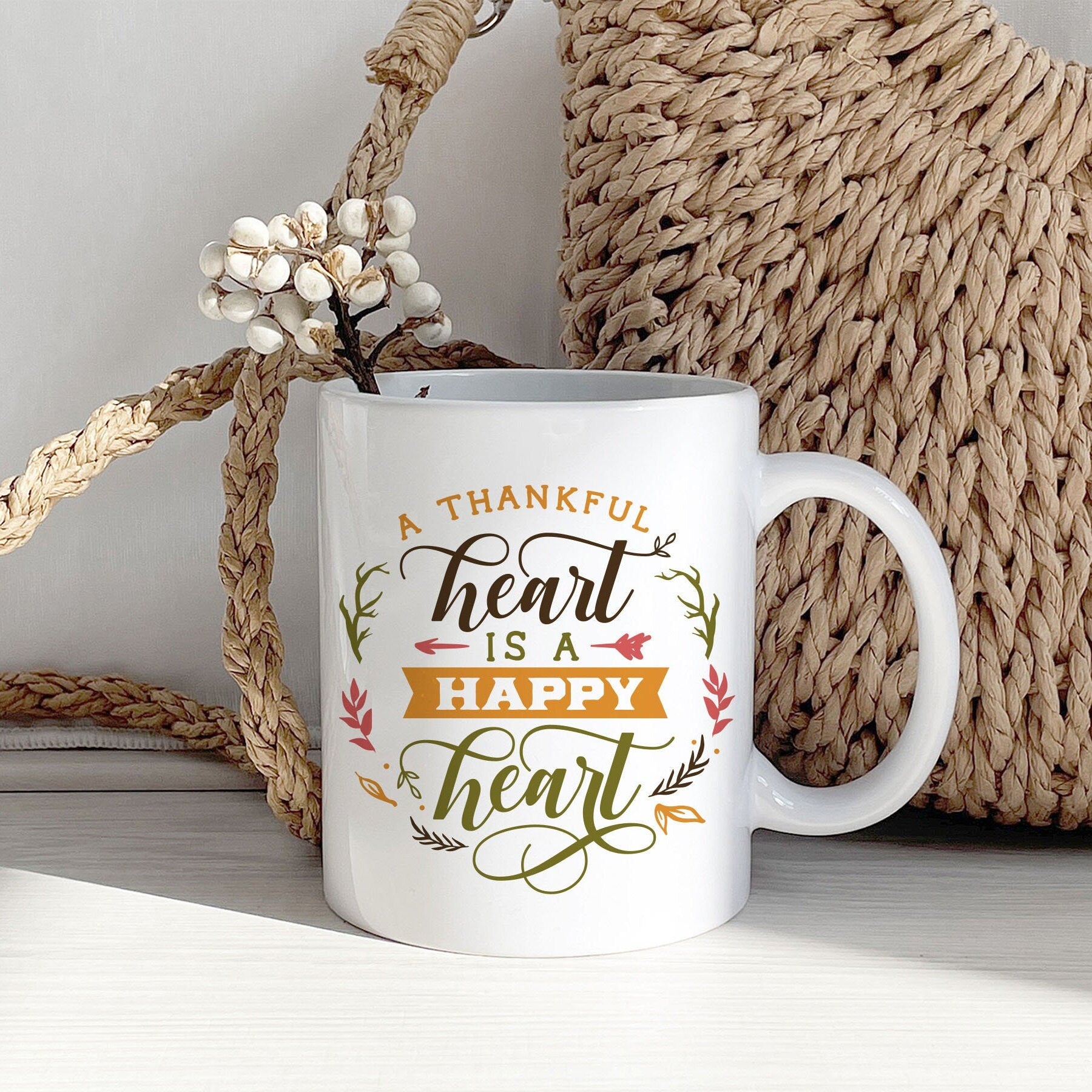 A Thankful Heart is Happy Heart Mug featuring autumn-themed design, perfect for Thanksgiving celebrations.