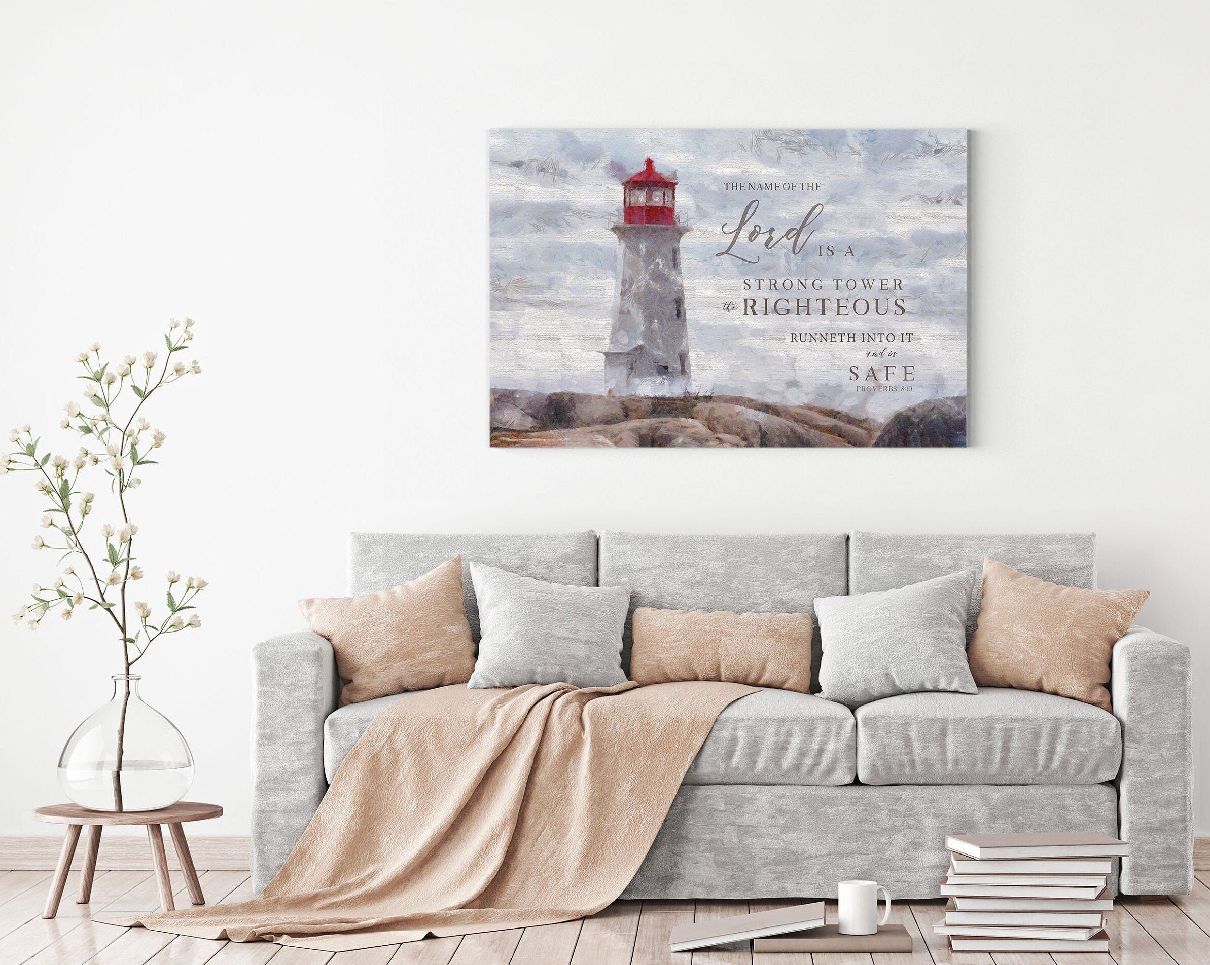 Canvas print featuring a lighthouse and the scripture 'The Name of the Lord is a strong tower' beautifully hand-lettered over a peaceful shore.