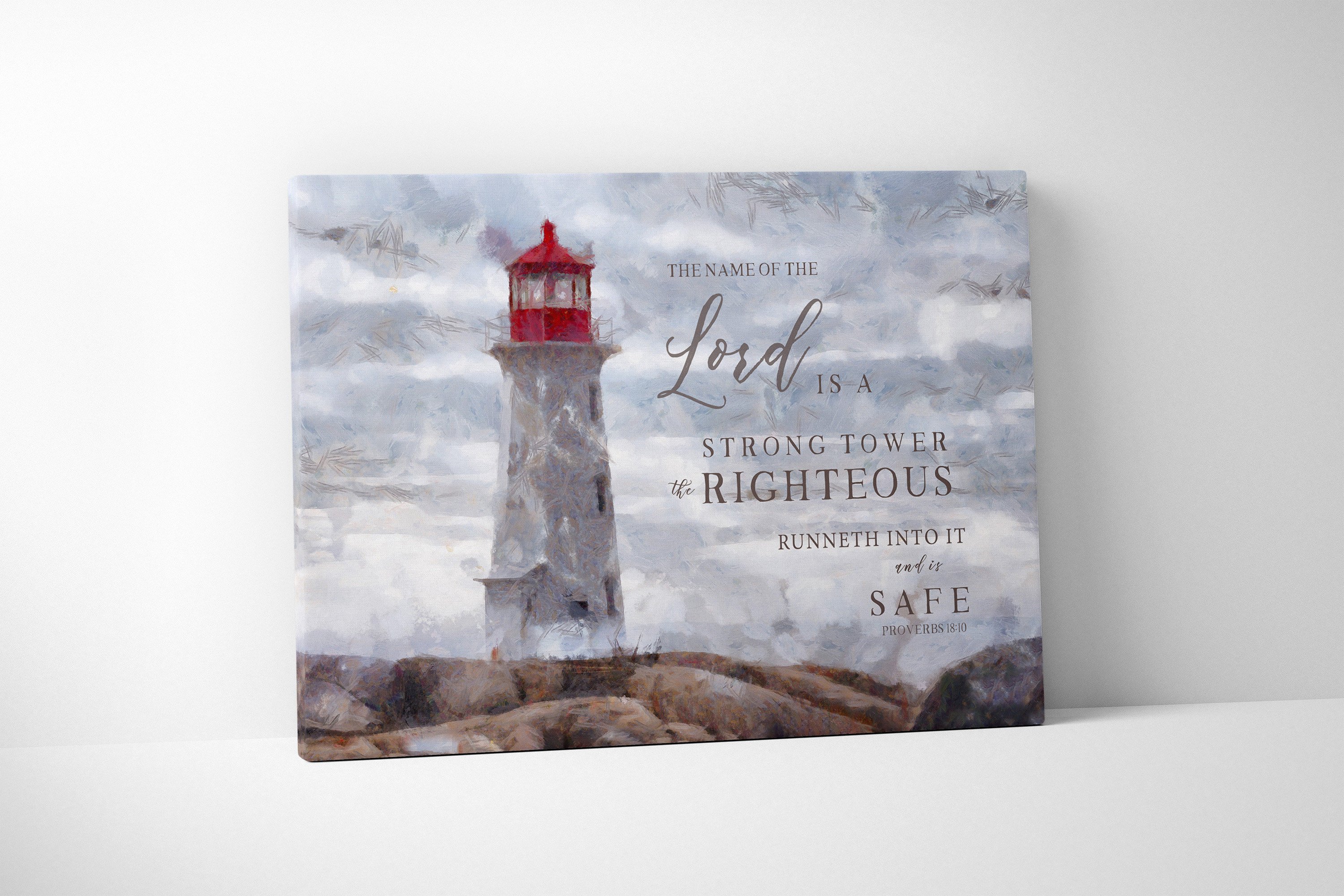 Canvas art featuring a lighthouse with the scripture 'The Name of the Lord is a strong tower' beautifully hand-lettered over a serene shore.