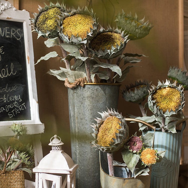 A beautiful handmade artificial sunflower stem with vibrant yellow petals, green leaves, and a brown stem, perfect for home decor.