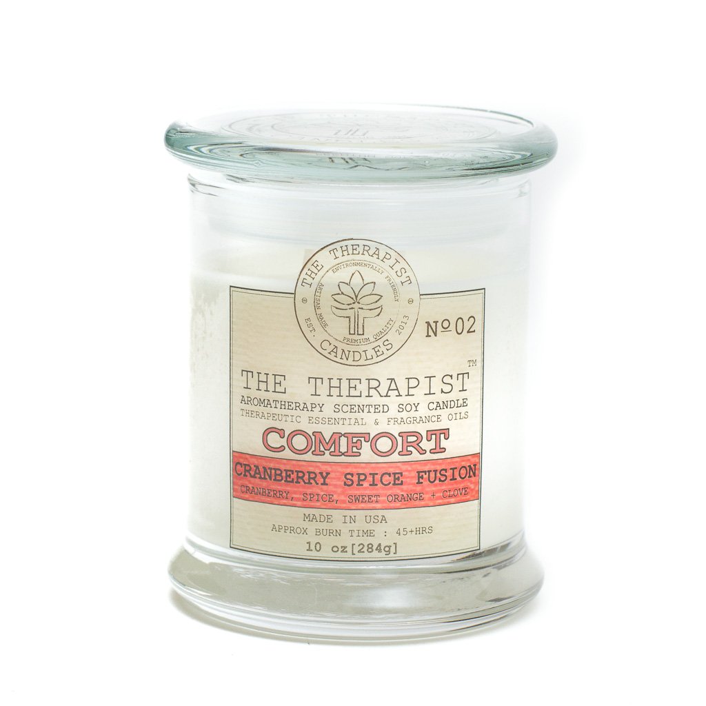 The Therapist Comfort Cranberry Spice Fusion Soy Candle in a thick glass container, showcasing its elegant design and inviting aroma.