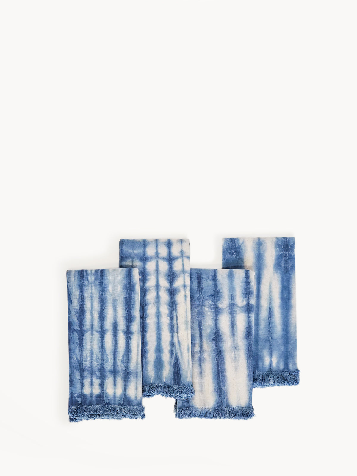 Set of four Indigo Blue Tie Dye Cotton Napkins, showcasing unique patterns and vibrant colors, perfect for enhancing table settings.