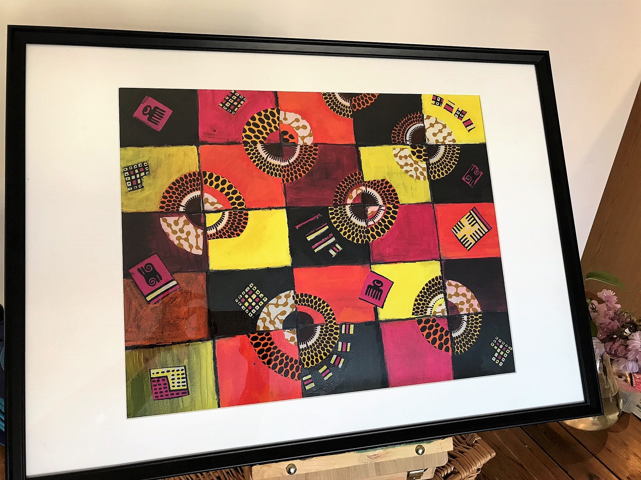 TIMELESS Recycled Ankara Fabric Art featuring vibrant colors and ancient African symbols on a canvas panel.