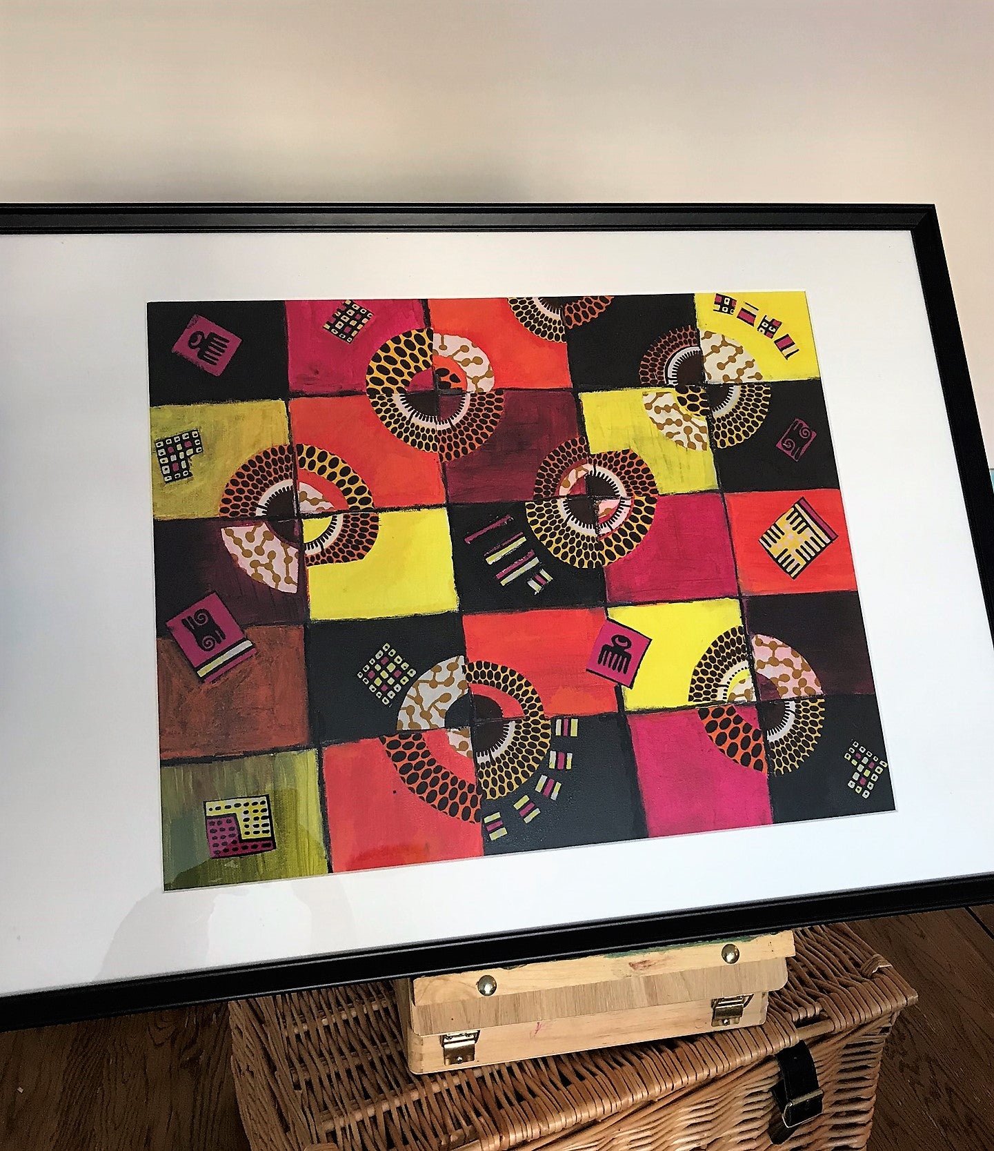 TIMELESS Recycled Ankara Fabric Art featuring vibrant colors and ancient African symbols on a canvas panel.