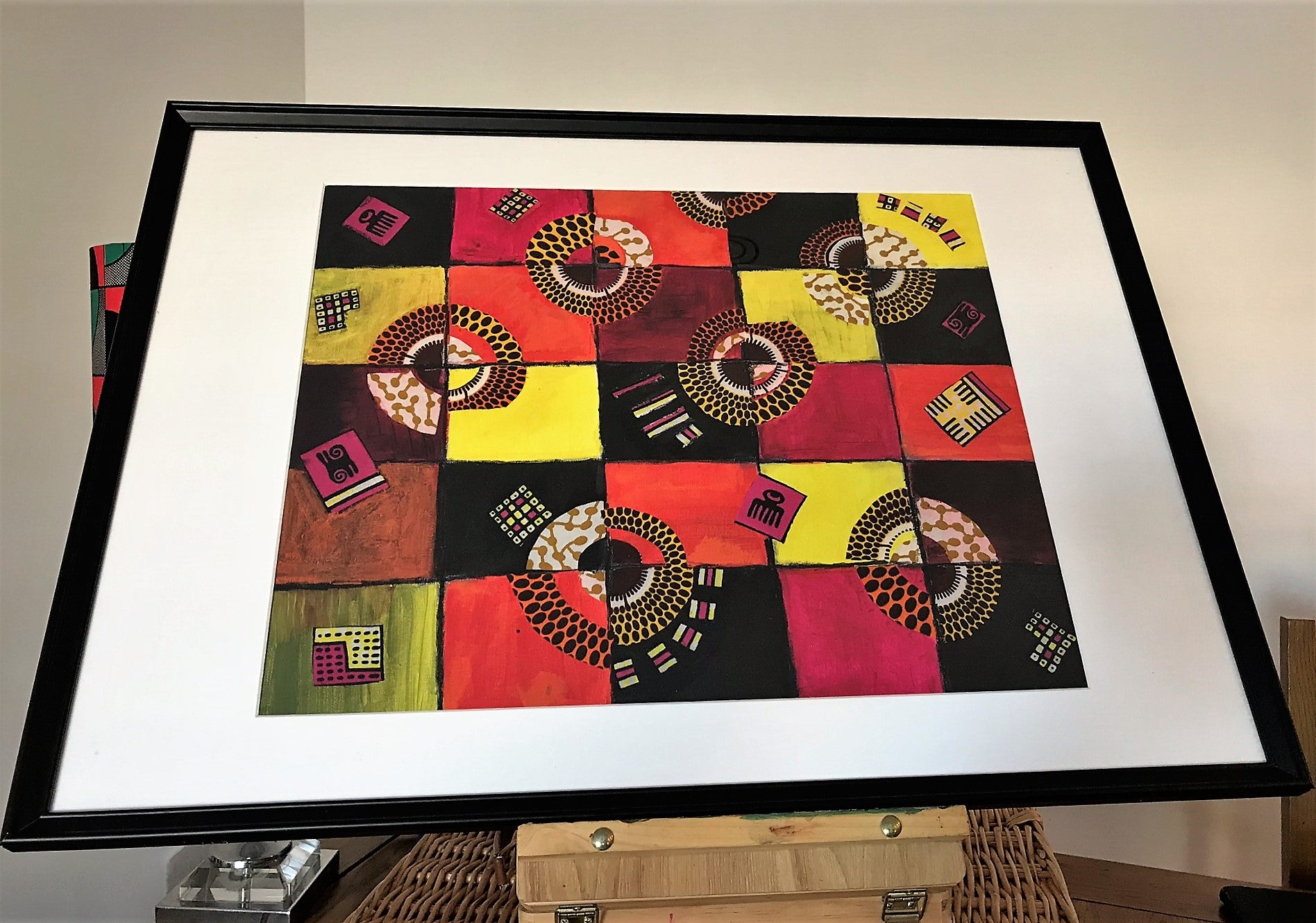 TIMELESS Recycled Ankara Fabric Art featuring vibrant colors and ancient African symbols on a canvas panel.