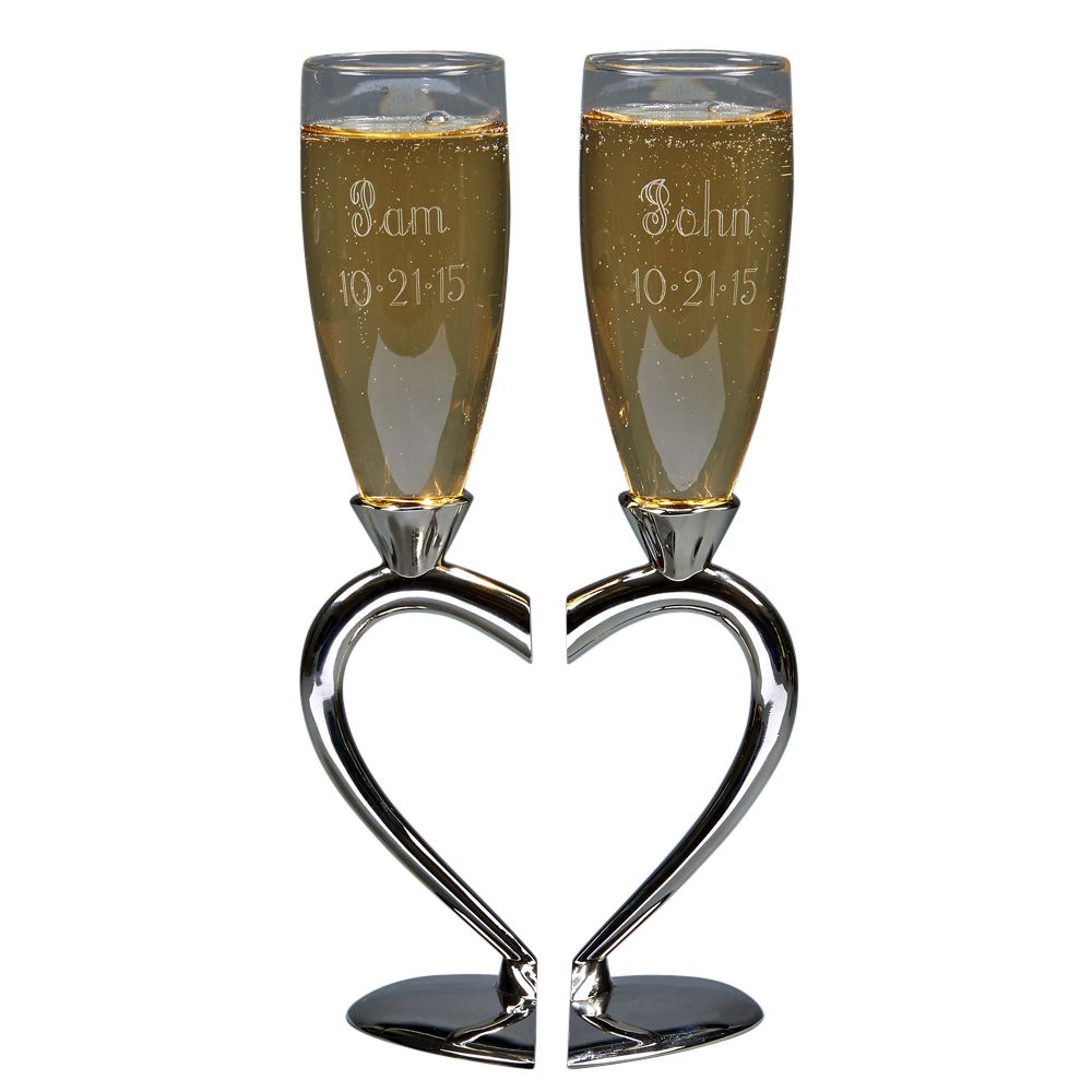 Elegant toasting goblets with heart-shaped base and stem, made of non-tarnish silver and glass, perfect for weddings.