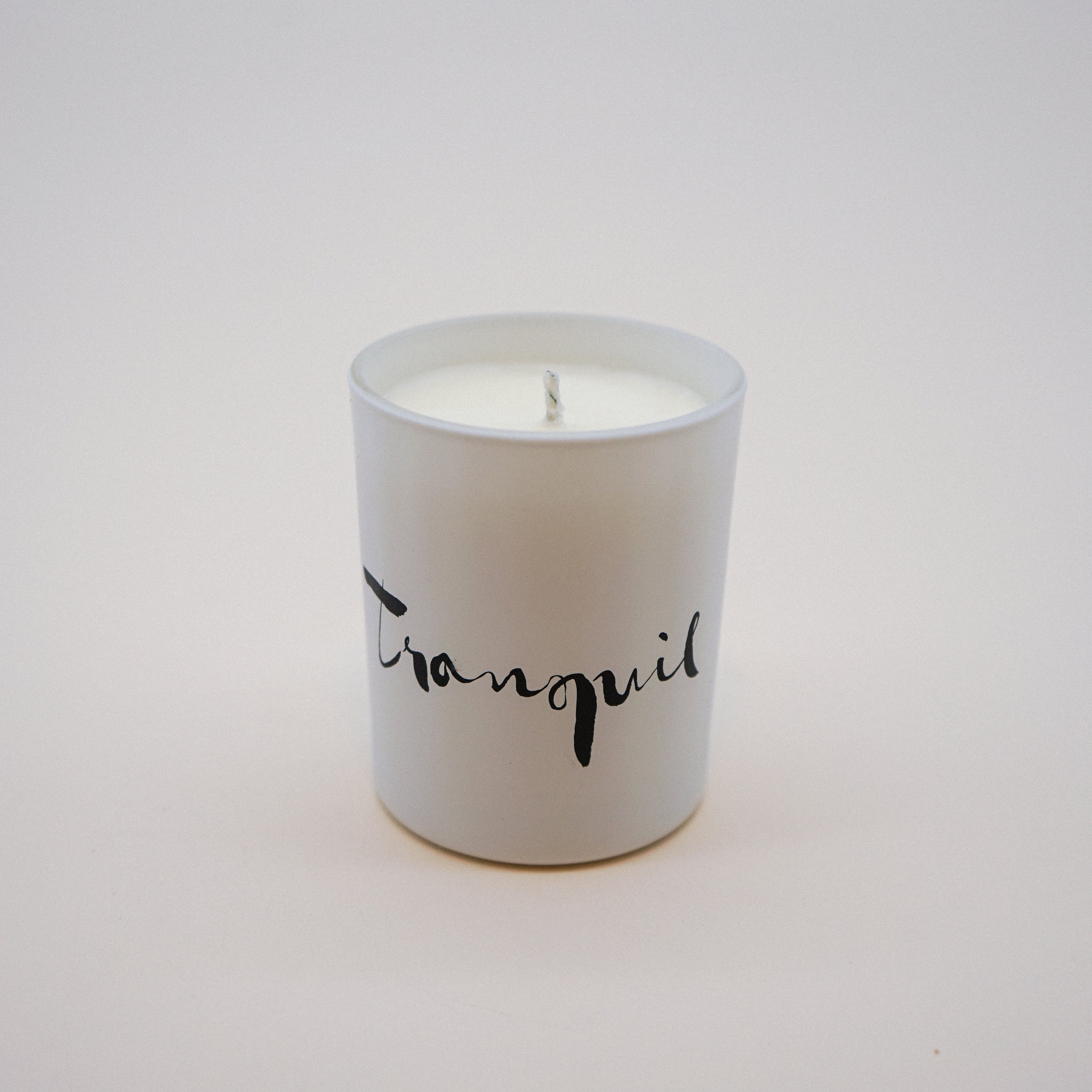 Tranquil Natural Wax Candle in white glass with brush painting design, featuring lavender and bergamot essential oils.