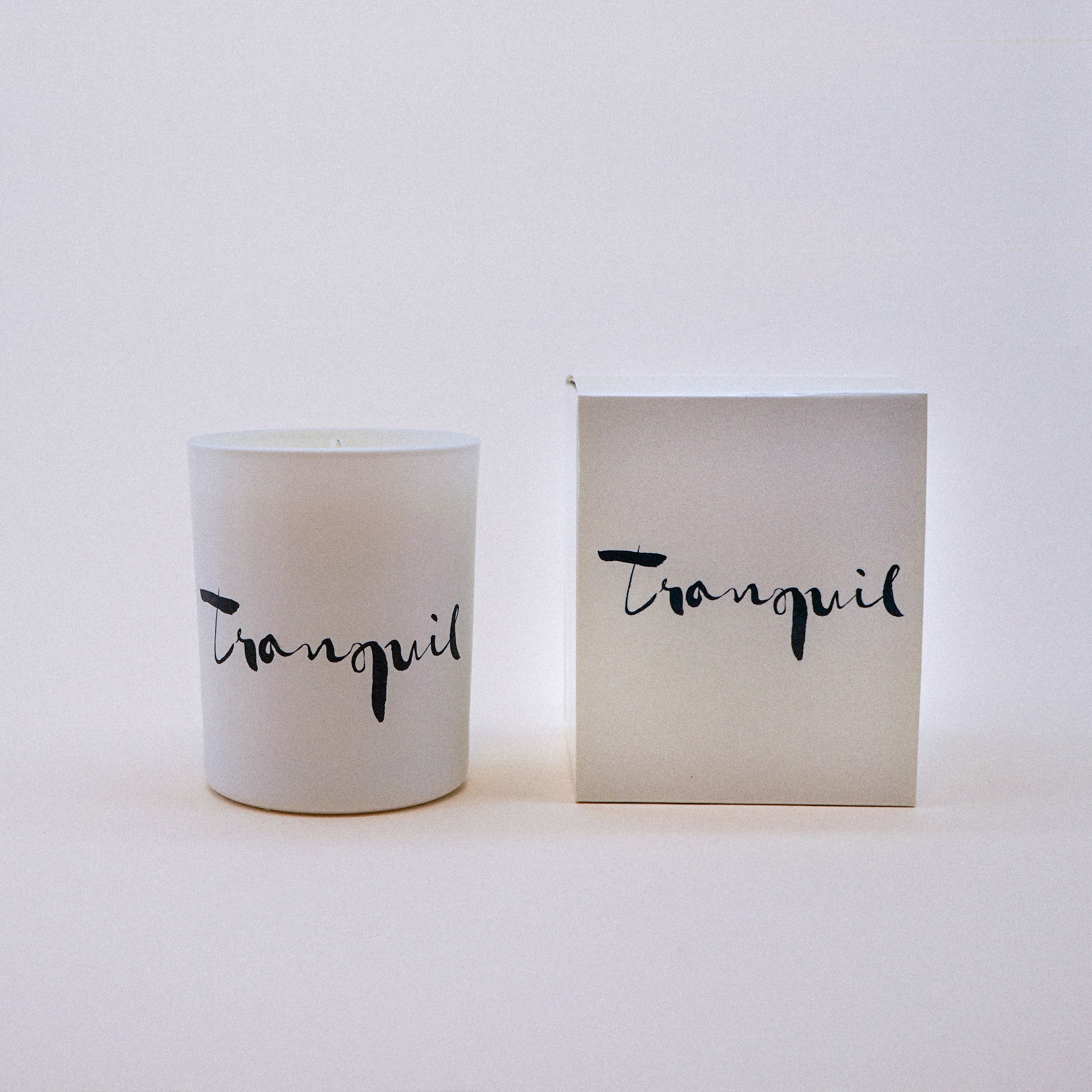 Tranquil Natural Wax Candle in white glass with brush painting design, featuring lavender and bergamot essential oils.