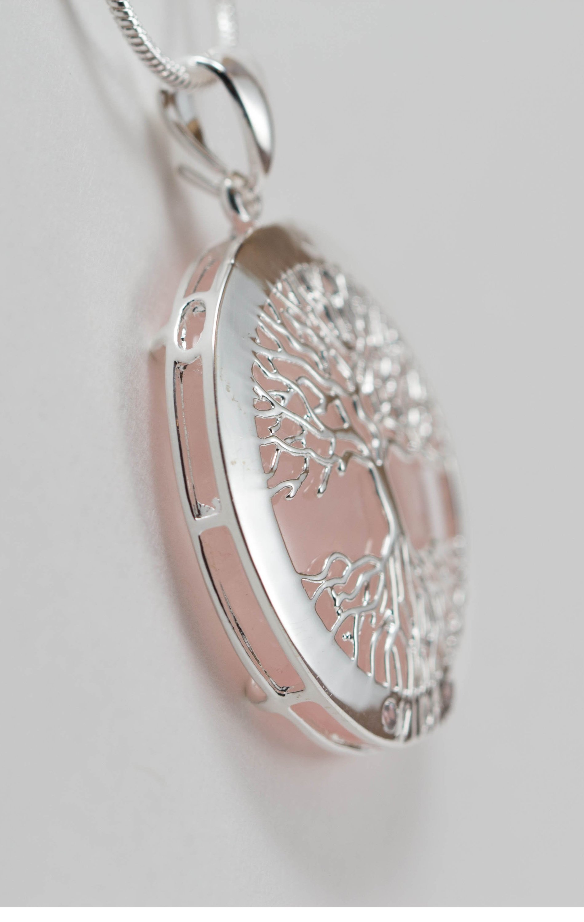 A beautiful Tree of Life Necklace featuring an intricate pendant on a silver chain, symbolizing growth and connection.