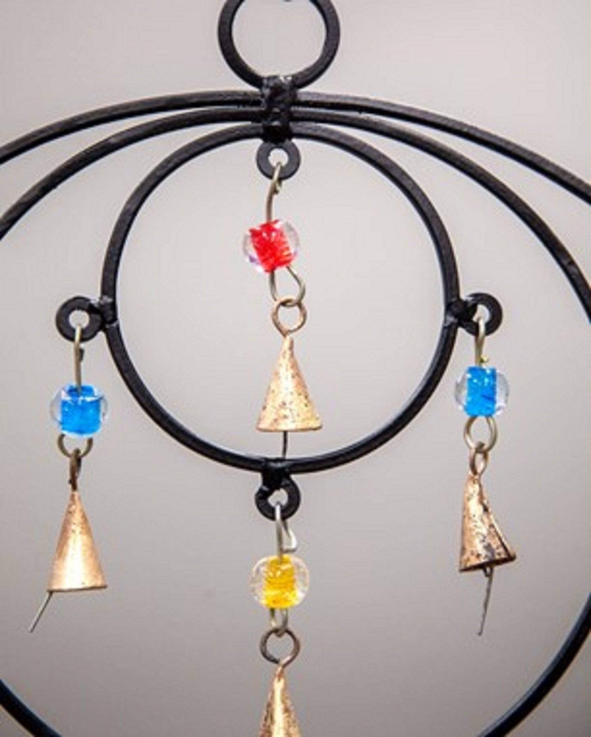 Triple Circle Chime featuring colorful glass beads and brass bells, handmade with sustainable materials, perfect for wall hanging decor.