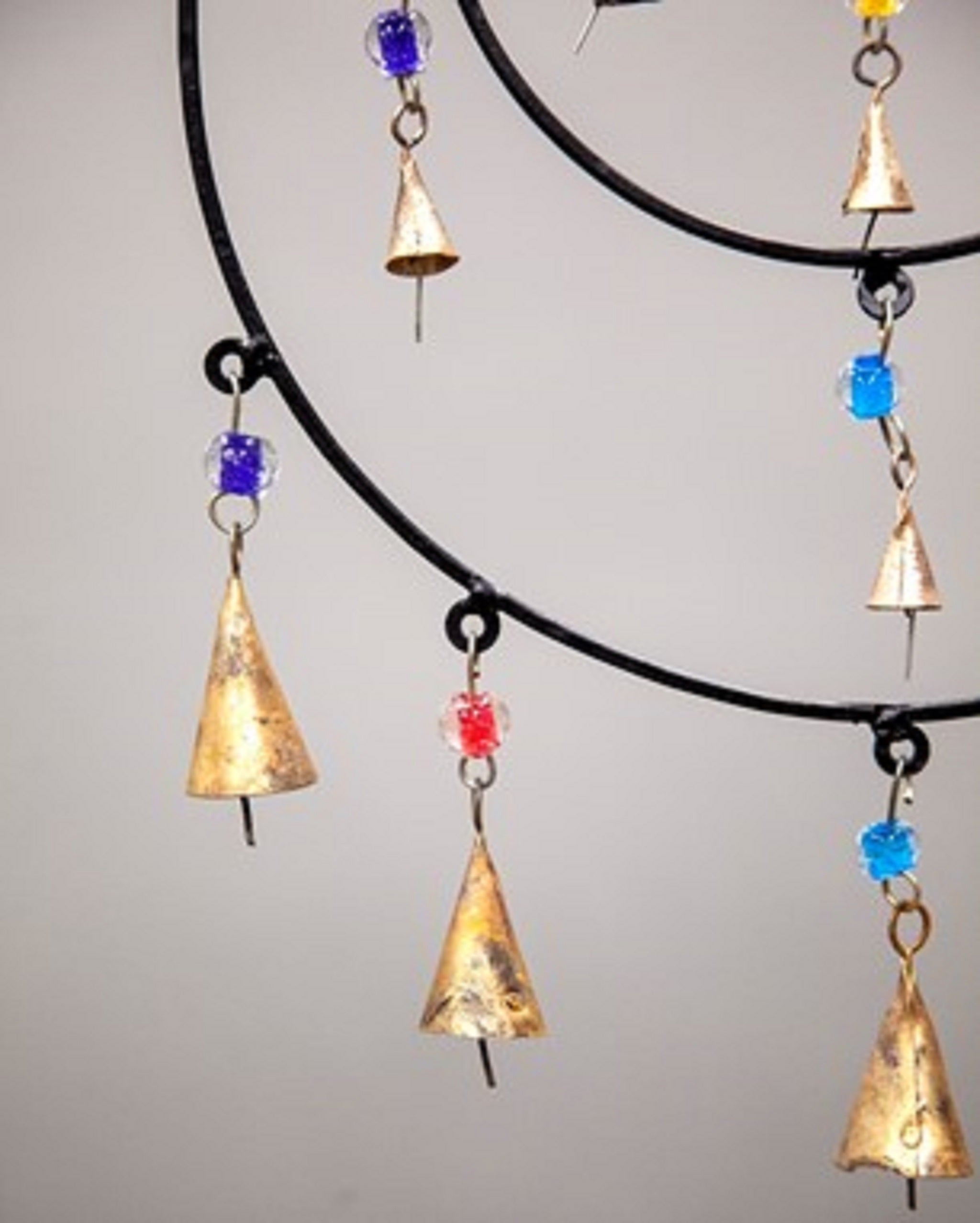 Triple Circle Chime featuring colorful glass beads and brass bells, handmade with sustainable materials, perfect for wall hanging decor.