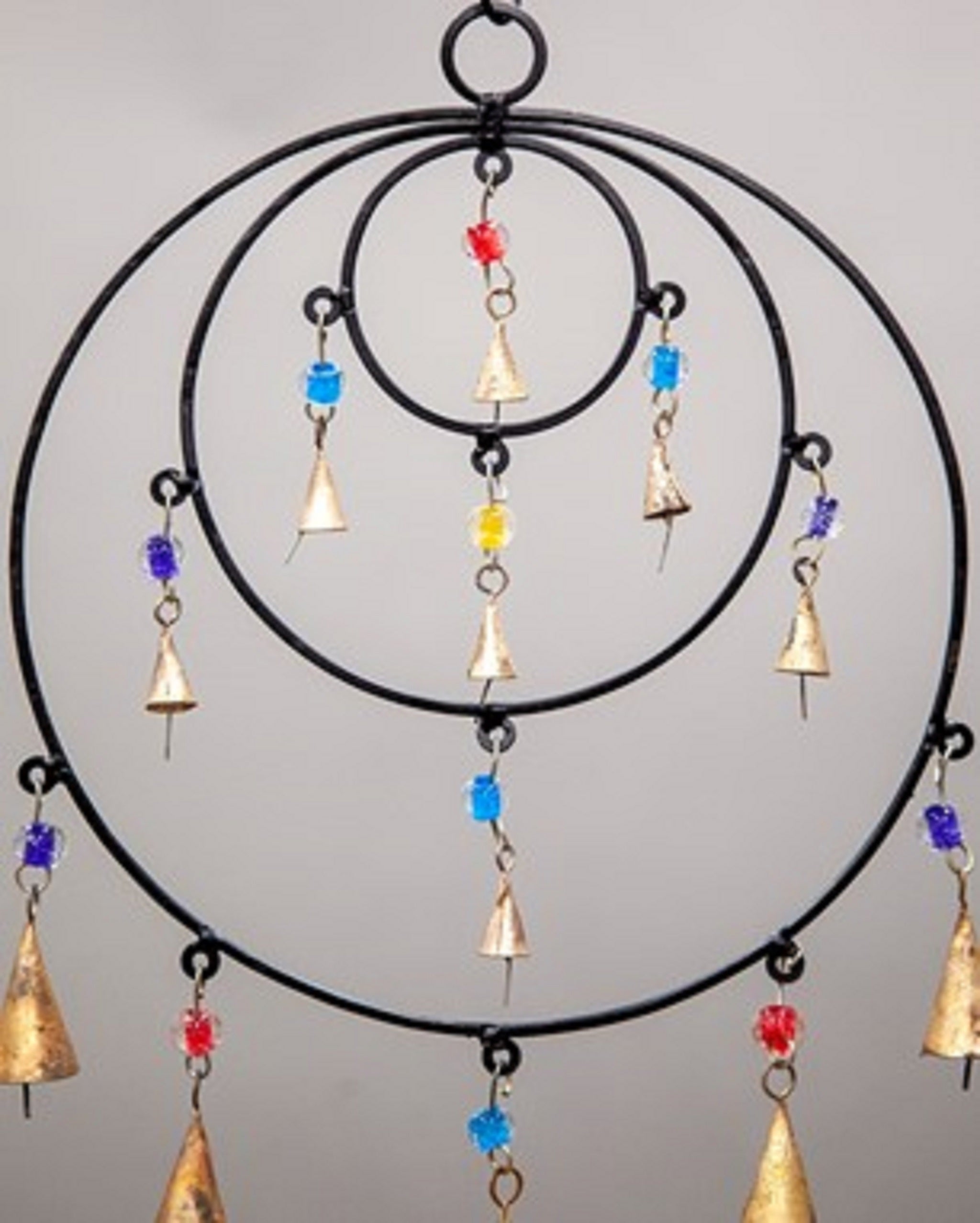 Triple Circle Chime featuring colorful glass beads and brass bells, handmade with sustainable materials, perfect for wall hanging decor.