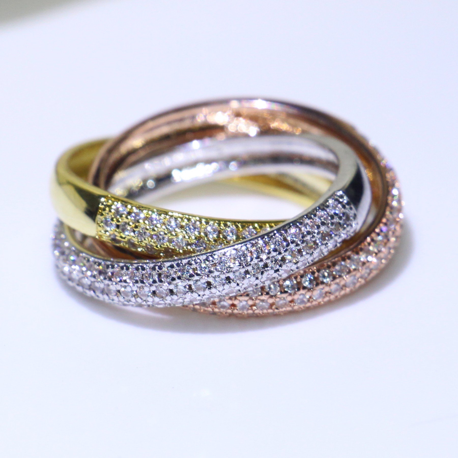 Triple Circles Ring in Gold, Rose Gold, and Silver showcasing elegant design and sparkling cubic zirconia stones.