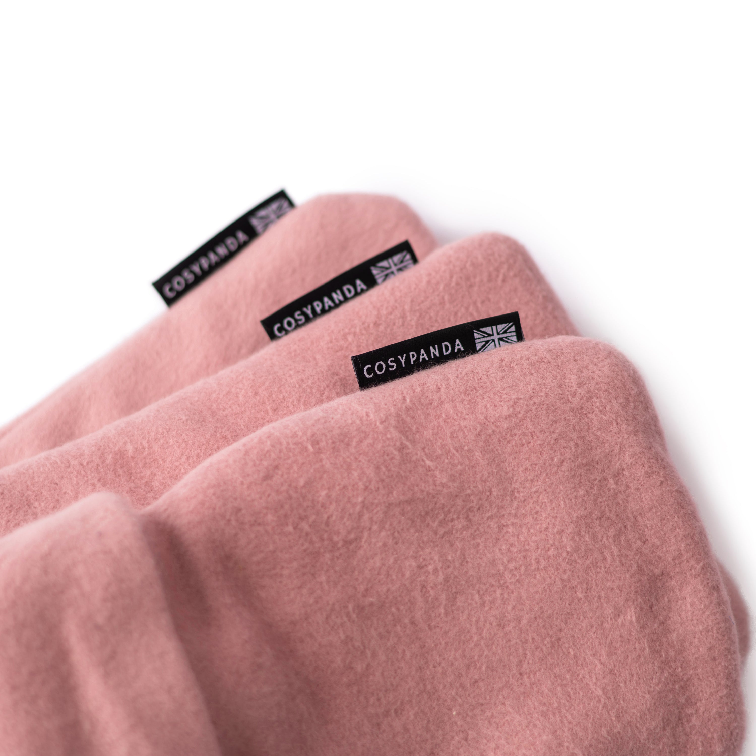 Triple Luxury Organic Cotton Pink Hot Water Bottle Gift Set featuring three sizes: long, regular, and mini, all in soft pink organic cotton covers.