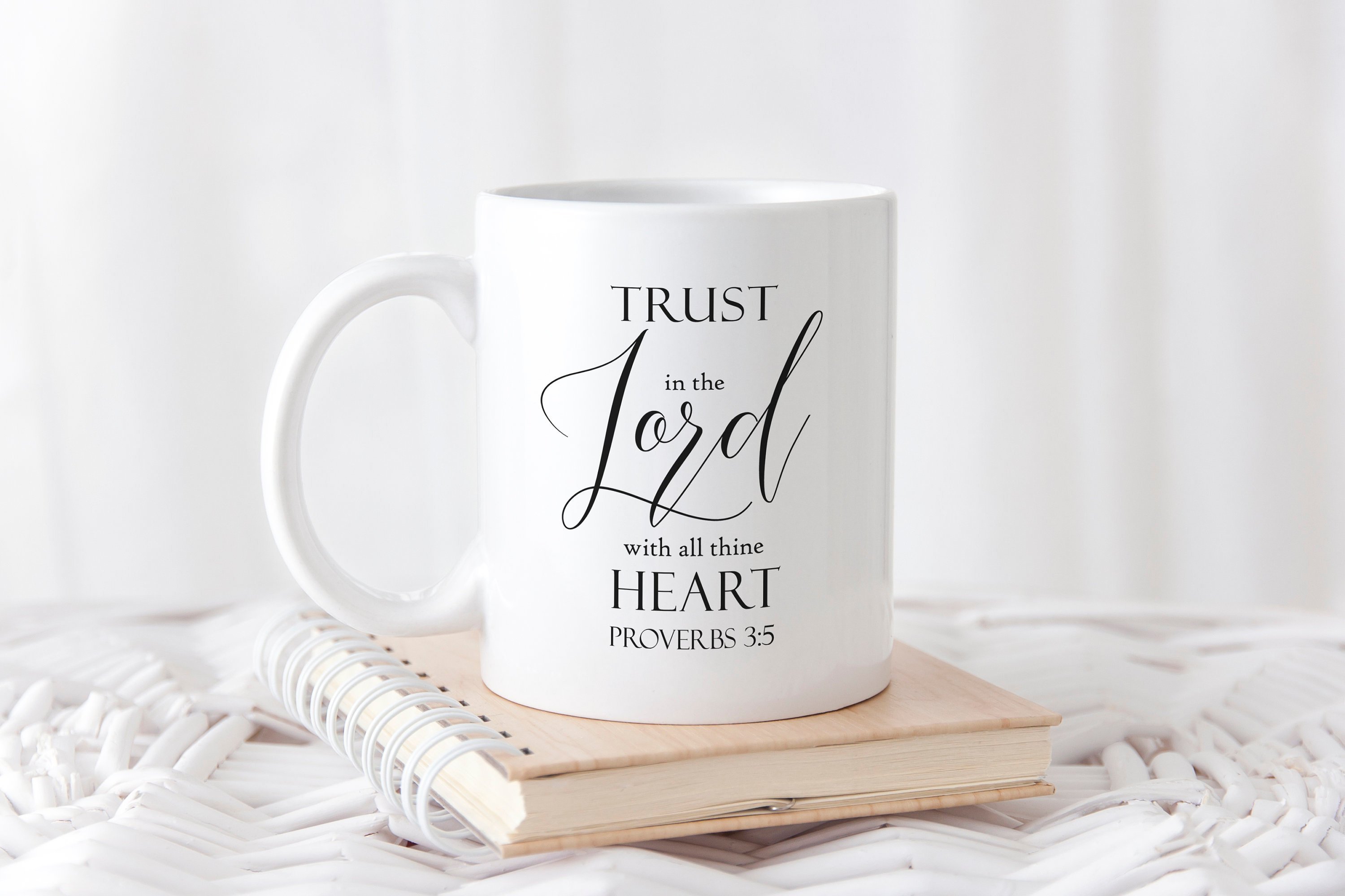 A ceramic mug featuring the quote 'Trust In The Lord With All Thine Heart' printed on both sides, available in two sizes.