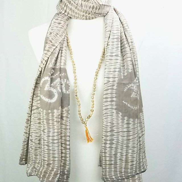 A beautifully crafted Tulsi OM prayer shawl featuring unique shibori patterns in natural dyes, perfect for meditation and prayer.