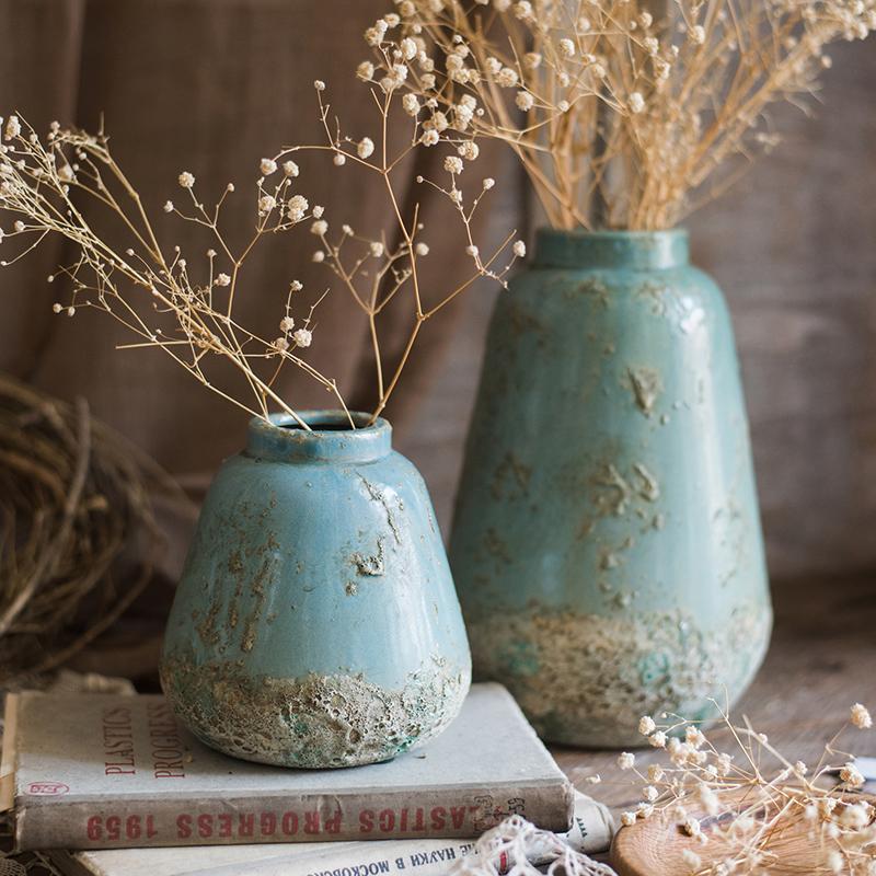 A beautifully handcrafted turquoise ceramic vase with a textured finish, showcasing unique color variations.