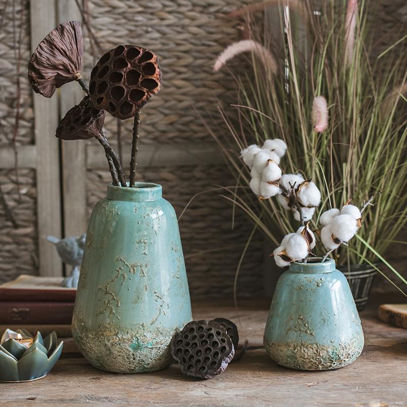 A beautifully handcrafted turquoise ceramic vase with a textured finish, showcasing unique color variations.