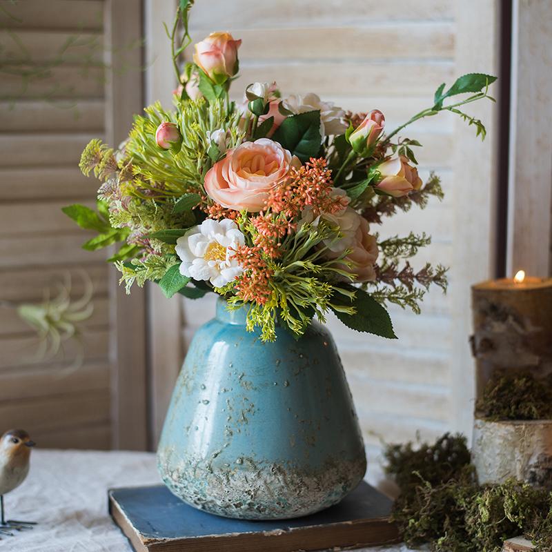 A beautifully handcrafted turquoise ceramic vase with a textured finish, showcasing unique color variations.