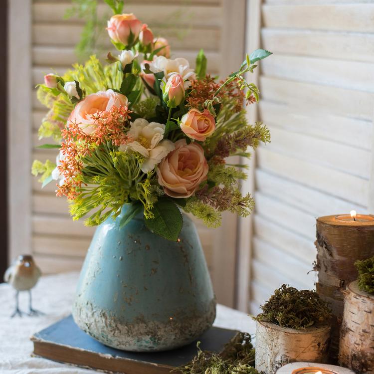 A beautifully handcrafted turquoise ceramic vase with a textured finish, showcasing unique color variations.