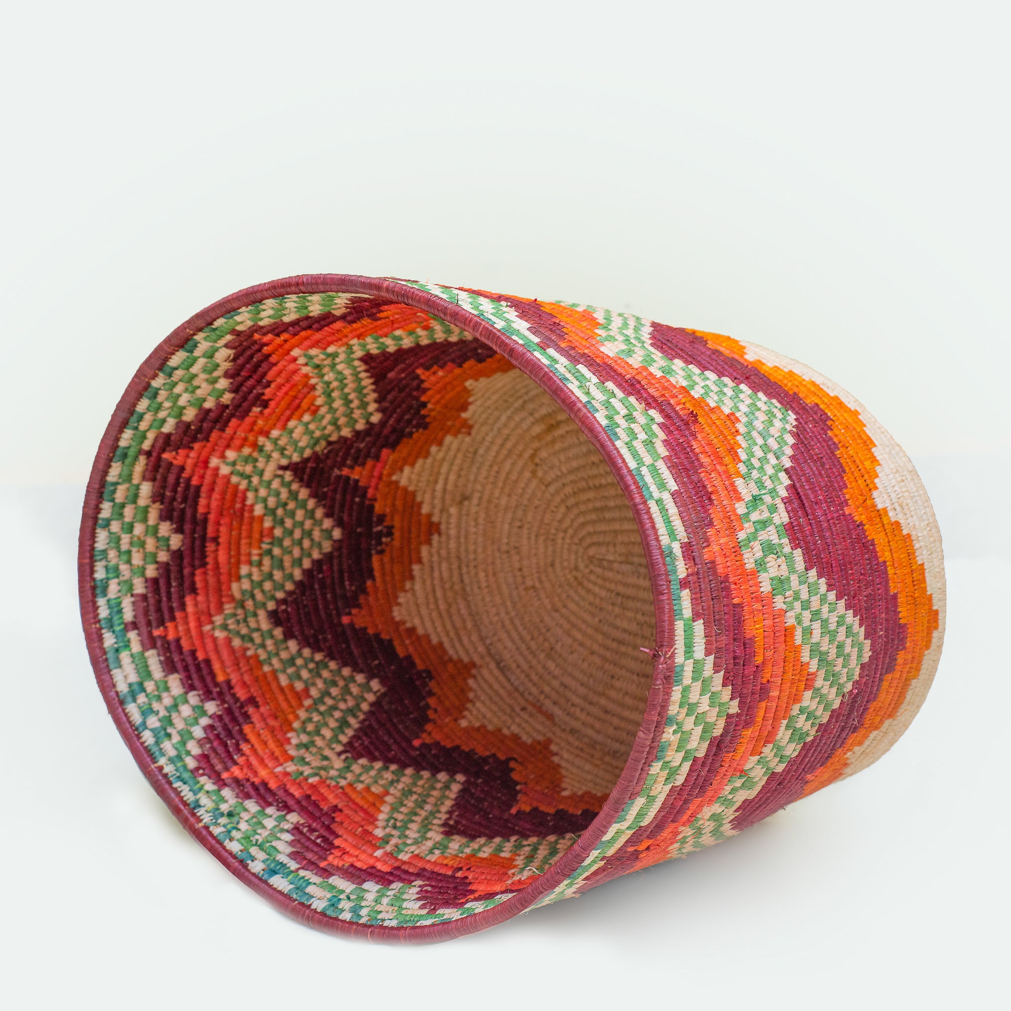 Colorful woven basket with zigzag pattern.