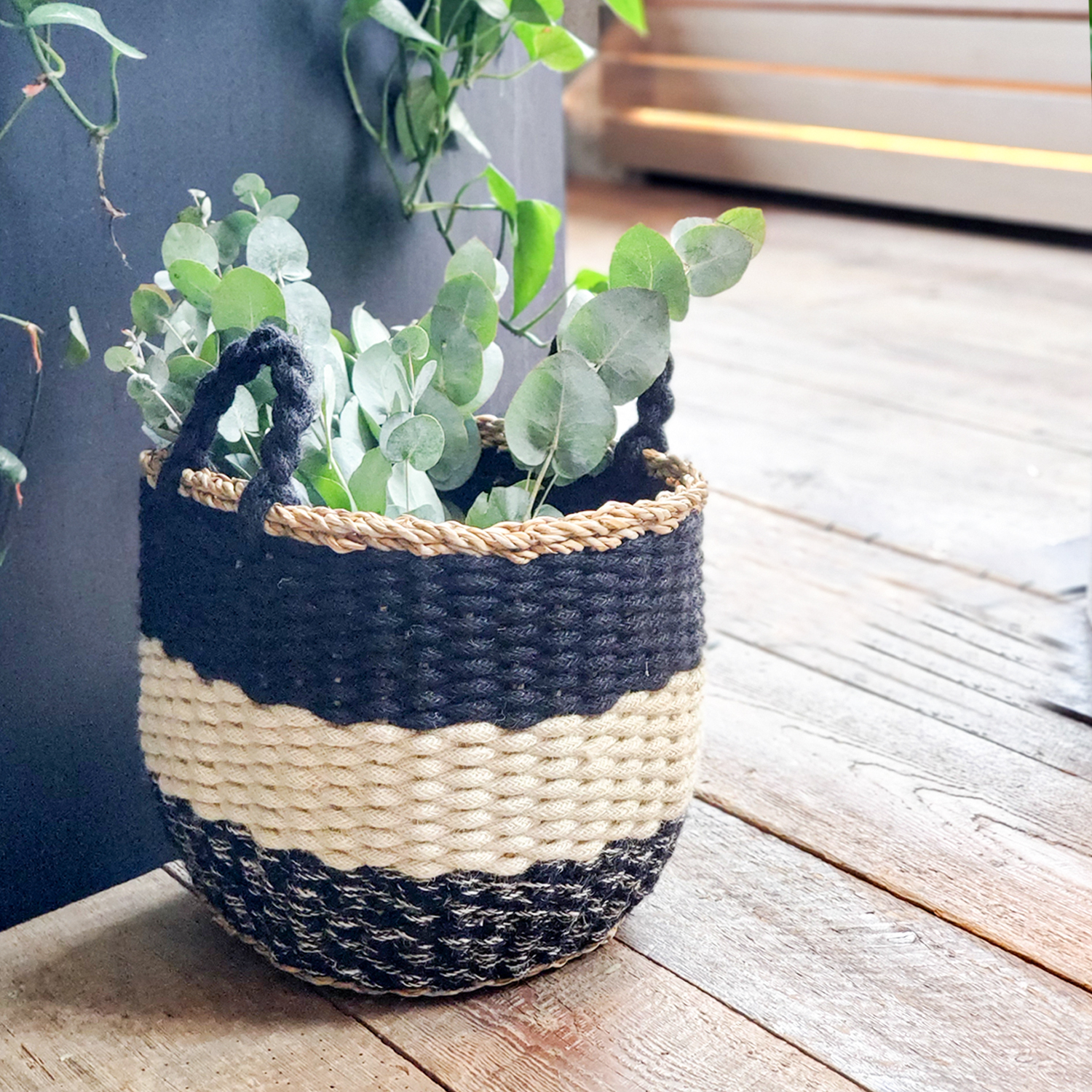 Ula Stripe Basket in Black, handwoven from seagrass and jute, featuring a stylish black and white stripe design, perfect for home storage.