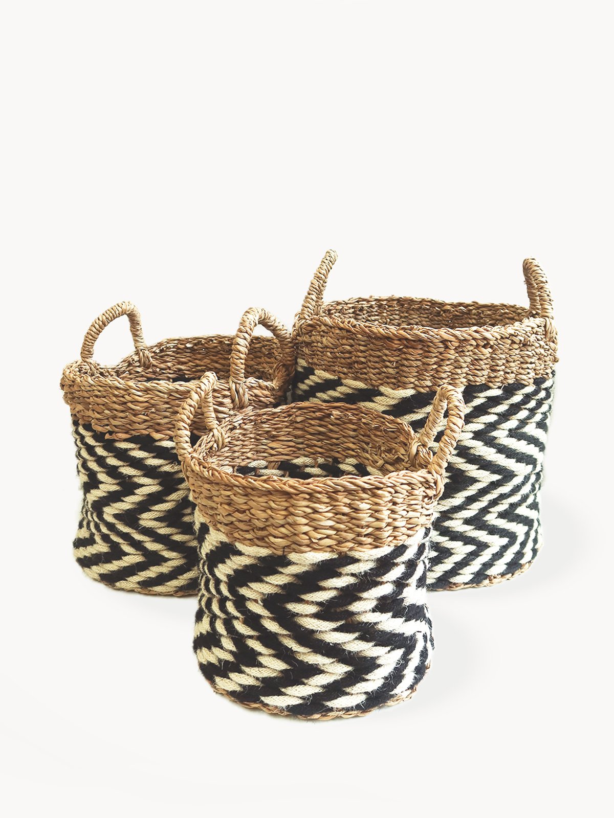 Ula Zigzag Basket handwoven from seagrass and jute, featuring a stylish zigzag pattern in natural, black, and white colors.