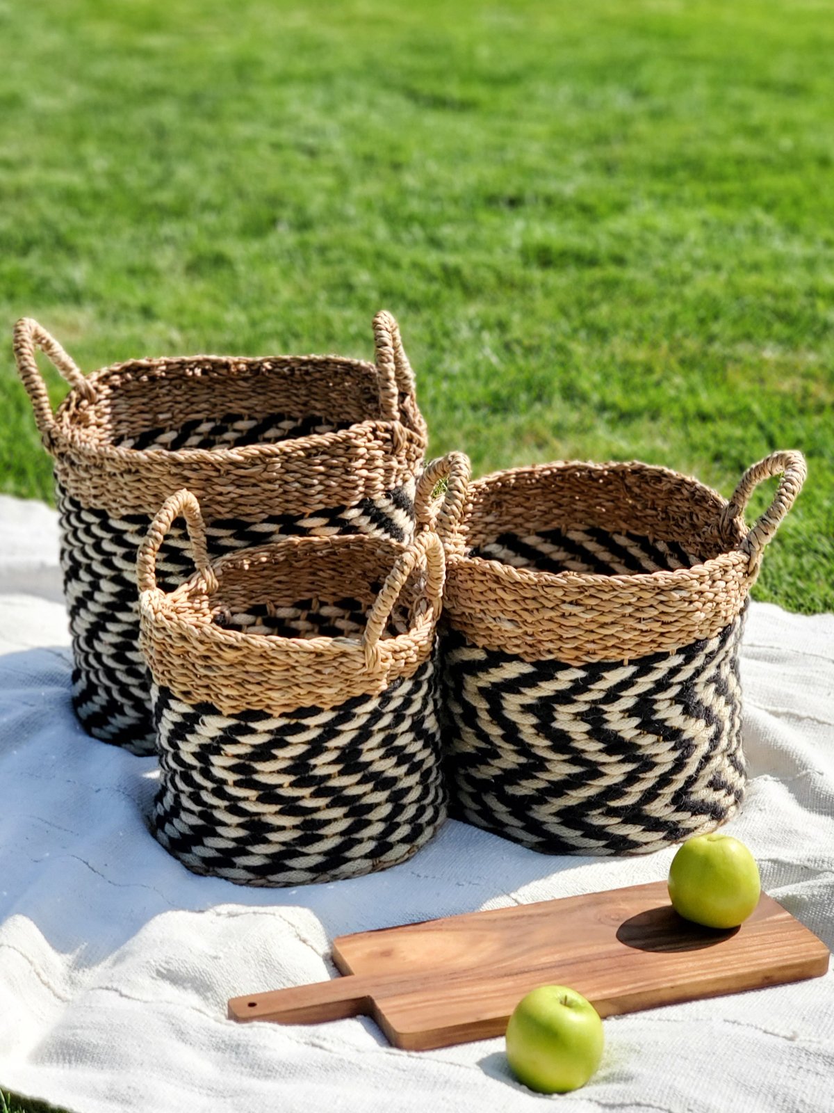 Ula Zigzag Basket handwoven from seagrass and jute, featuring a stylish zigzag pattern in natural, black, and white colors.