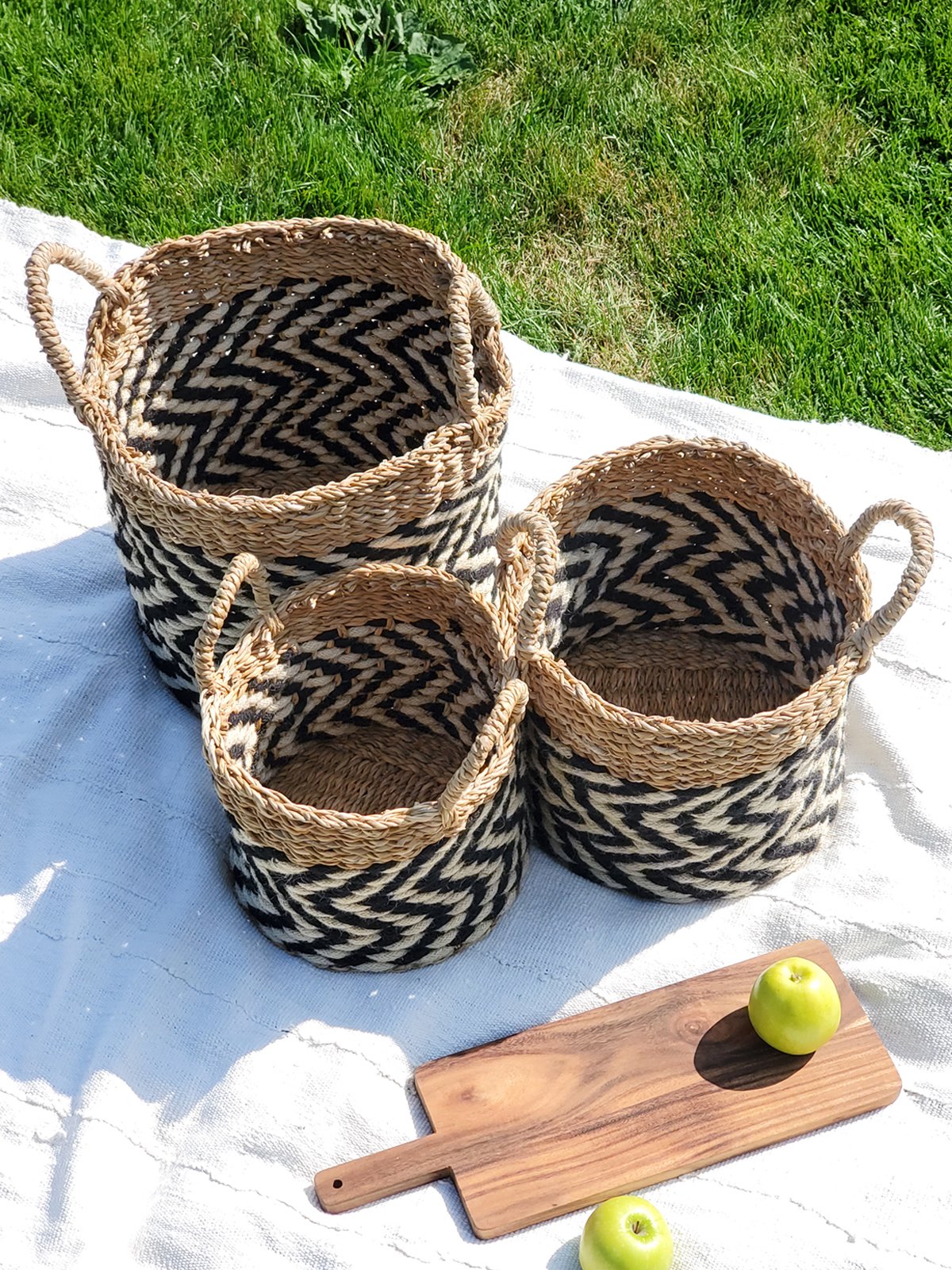 Ula Zigzag Basket handwoven from seagrass and jute, featuring a stylish zigzag pattern in natural, black, and white colors.