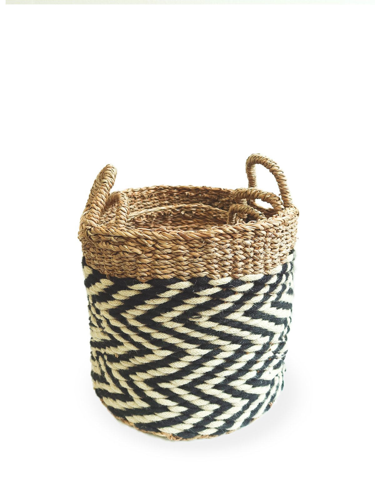 Ula Zigzag Basket handwoven from seagrass and jute, featuring a stylish zigzag pattern in natural, black, and white colors.