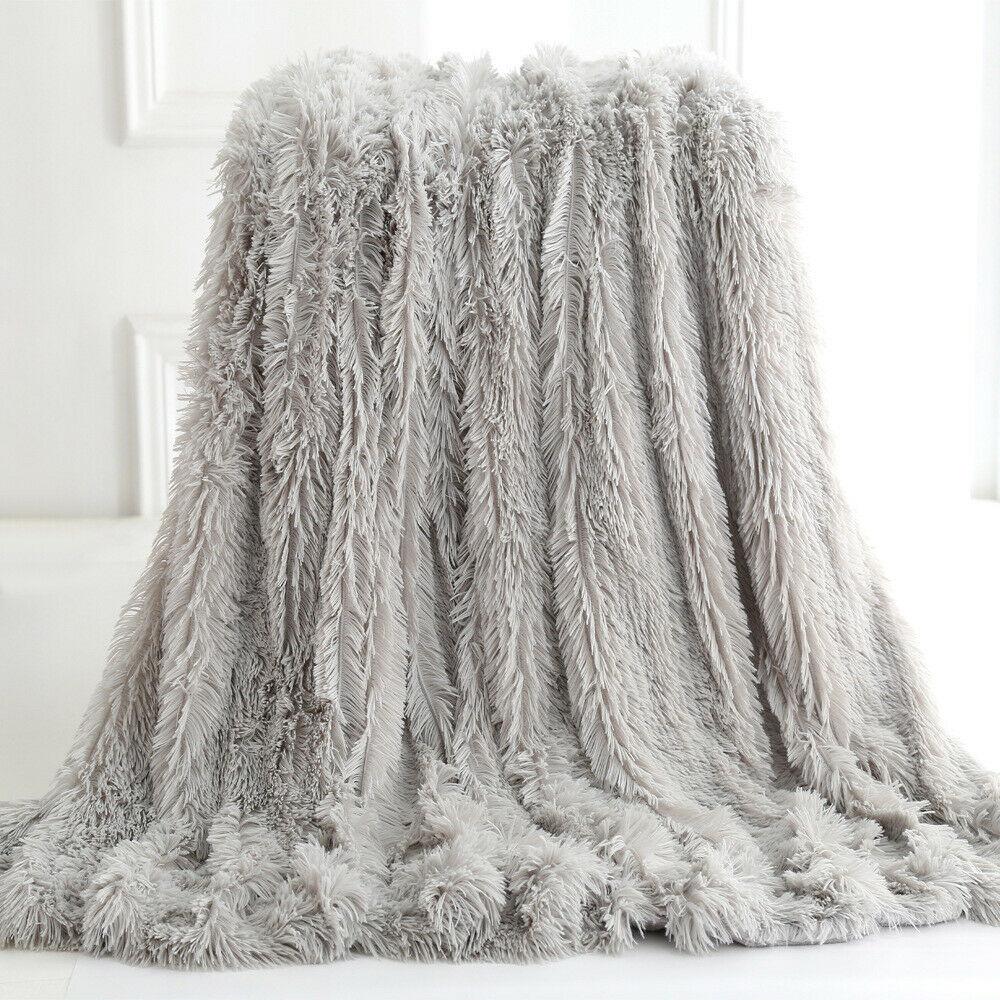 Ultra Soft Faux Fur Throw Blanket in pink, gray, white, and coffee colors, showcasing its plush texture and reversible design.