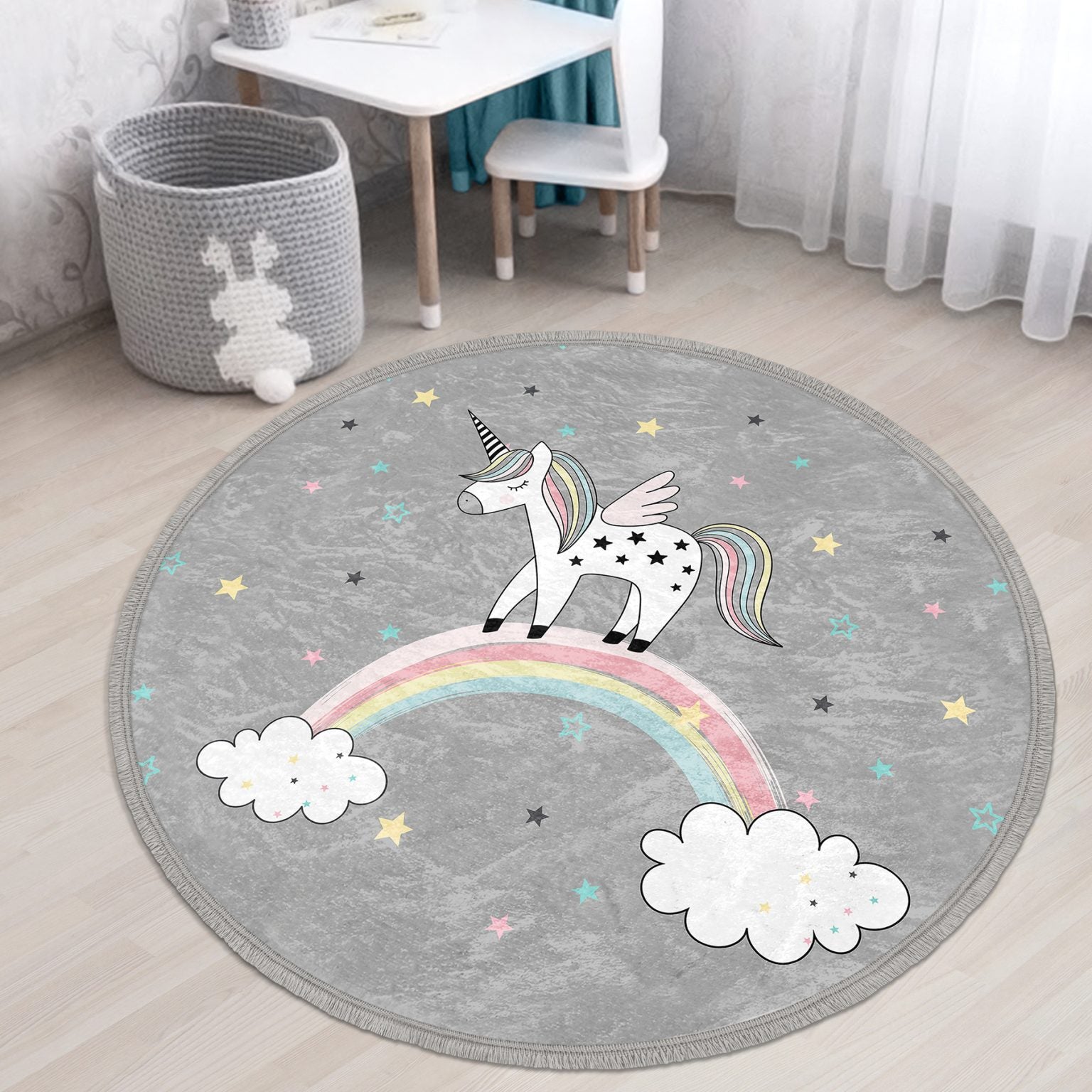 A colorful unicorn printed circle rug designed for kids' rooms, featuring soft velvet fabric and fringes, perfect for nurseries and play areas.