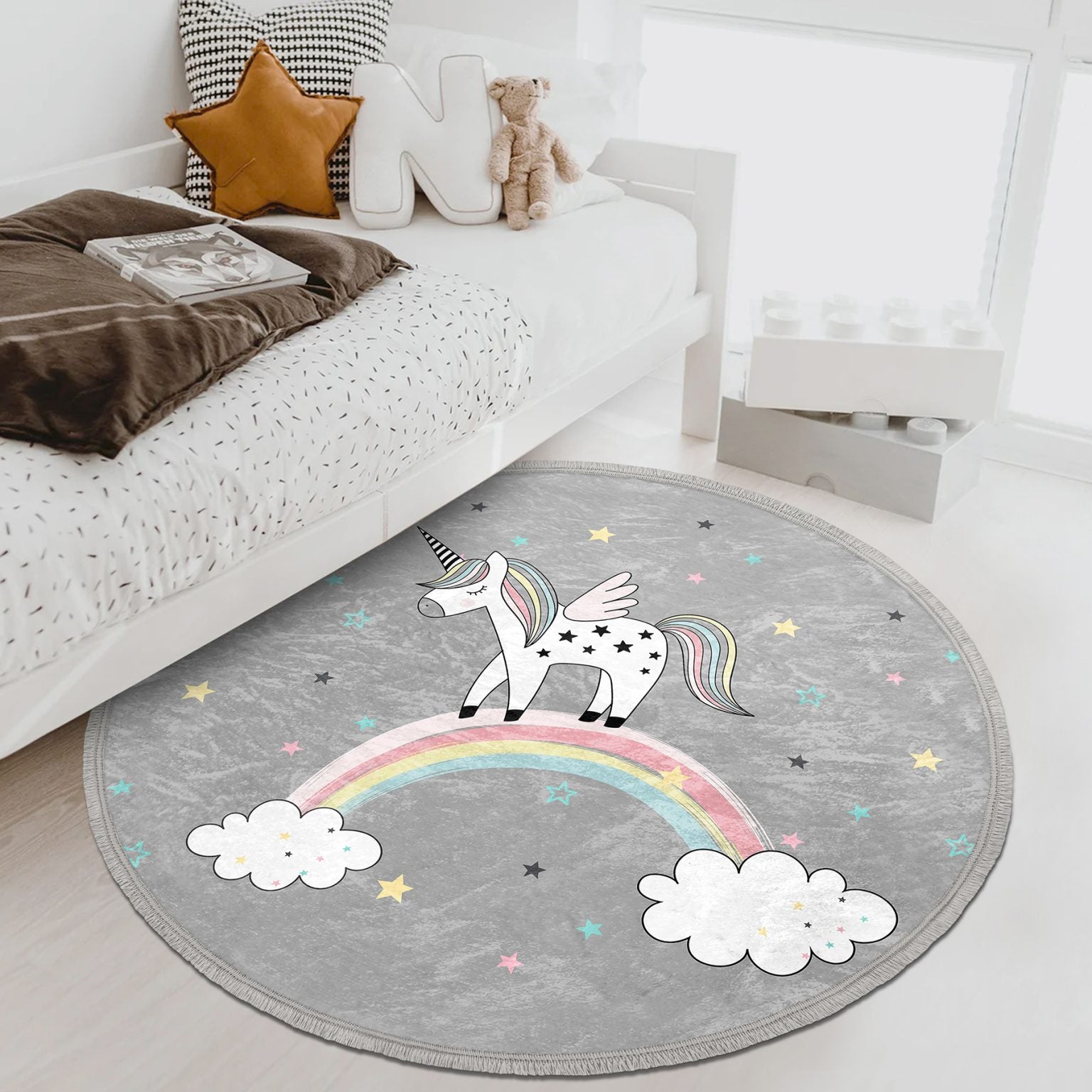 A colorful unicorn printed circle rug designed for kids' rooms, featuring soft velvet fabric and fringes, perfect for nurseries and play areas.