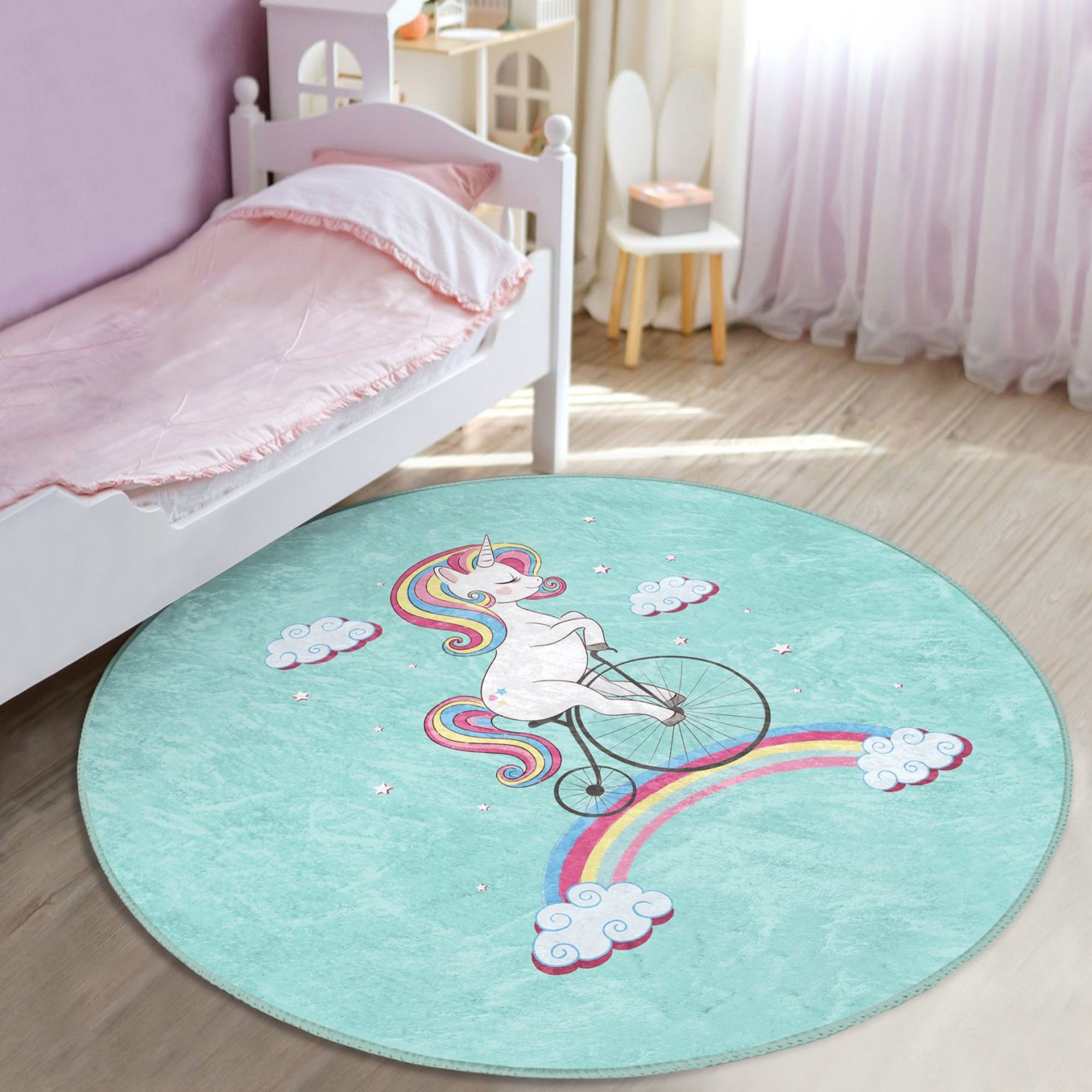 A colorful kids rug featuring a unicorn riding a bicycle on a rainbow, designed for playful and cozy environments.