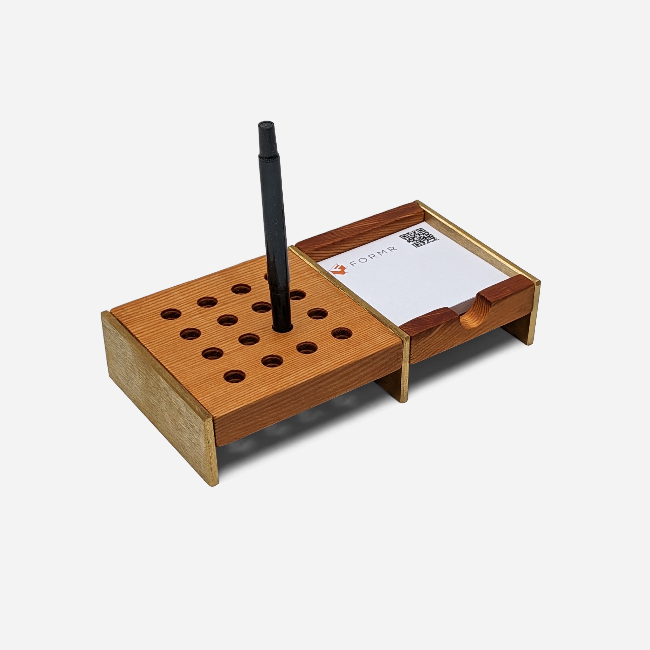 Unite desk organizer made of Doug Fir wood with brass accents, featuring compartments for pens and notes.