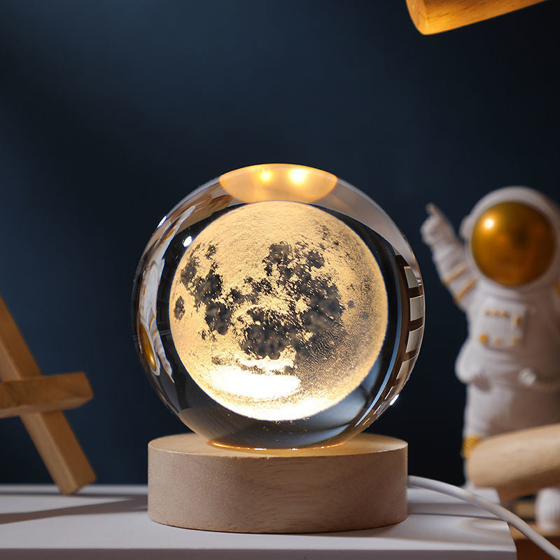 A luminous crystal ball night light with a soft glow, perfect for bedroom decor, showcasing its elegant design and compact size.