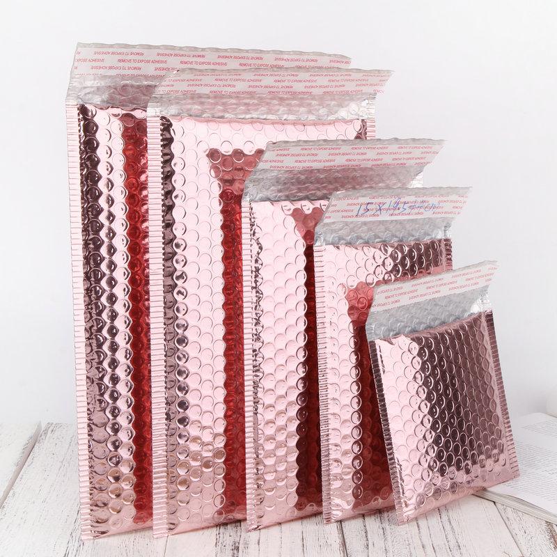 Pack of 10 metallic padded bubble mailers in rose gold, rose pink, and holographic colors, showcasing their self-sealing adhesive and durable construction.