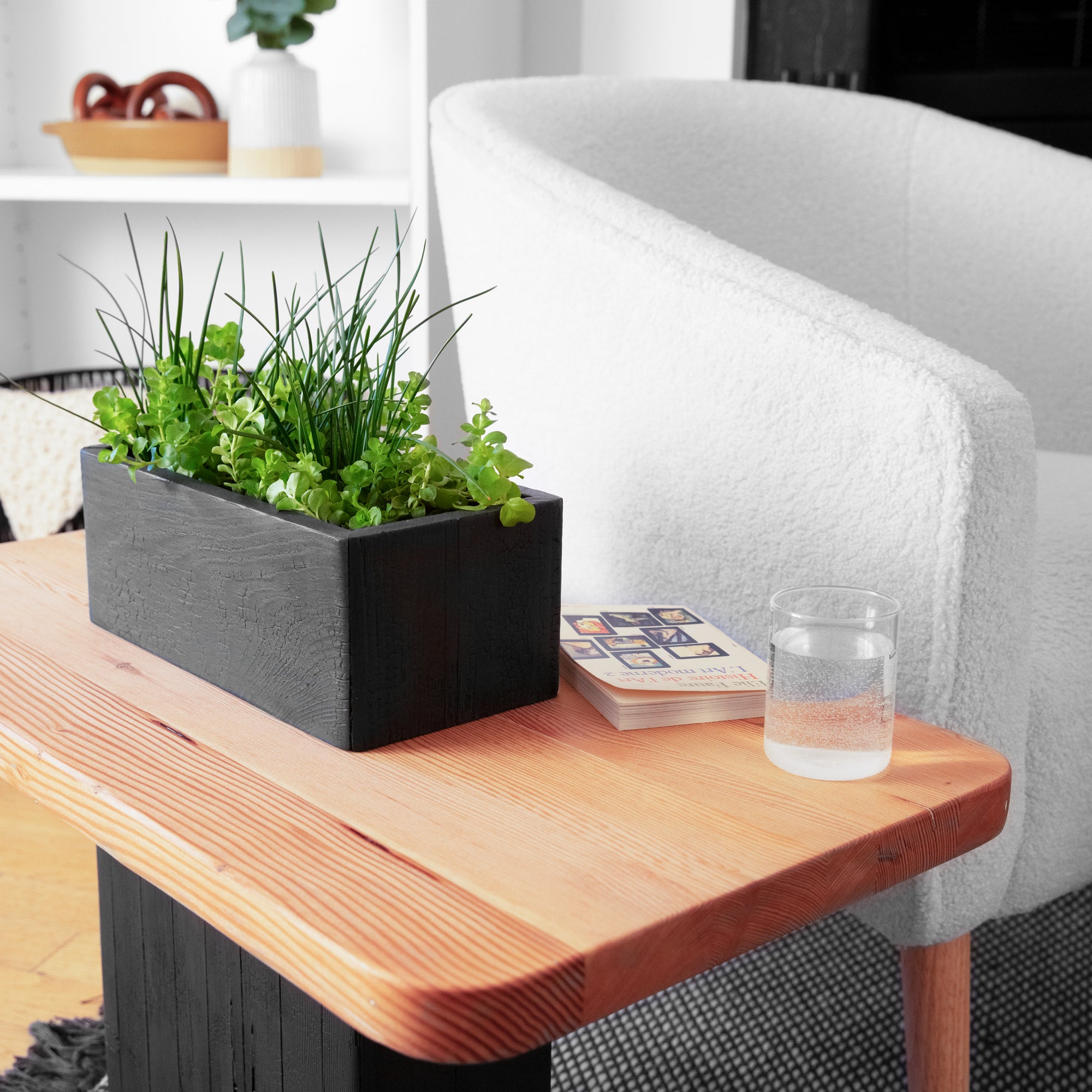 VegeTABLE side table featuring a glass vase and elegant wood design, perfect for plant lovers.