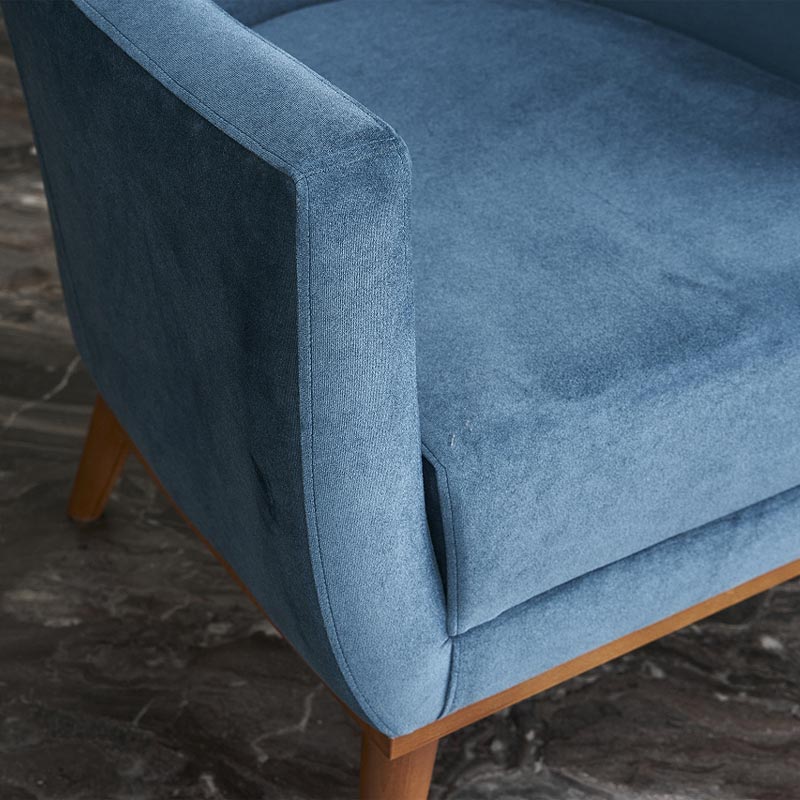 REGATA Blue Velvet Armchair with natural beech wood legs, showcasing plush upholstery and elegant design.