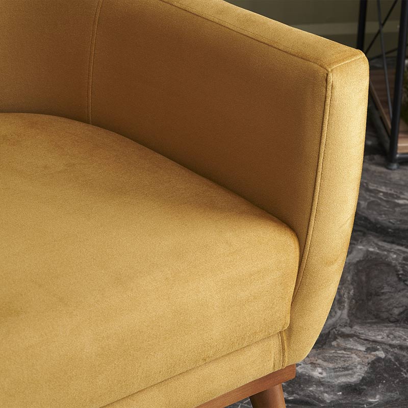 REGATA Velvet Armchair in mustard color with natural beech wood legs, showcasing its plush upholstery and elegant design.