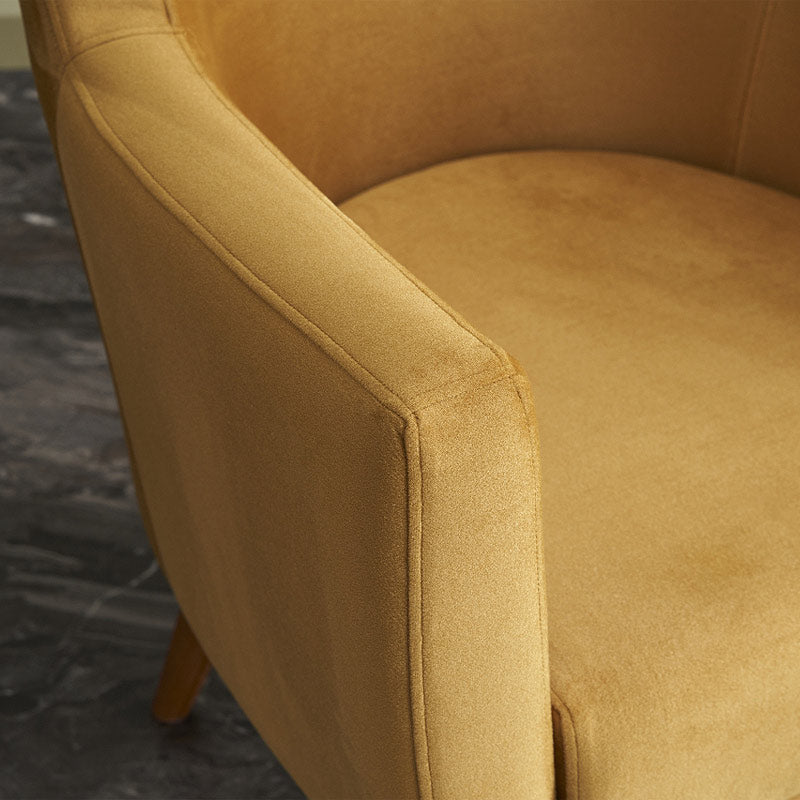 REGATA Velvet Armchair in mustard color with natural beech wood legs, showcasing its plush upholstery and elegant design.