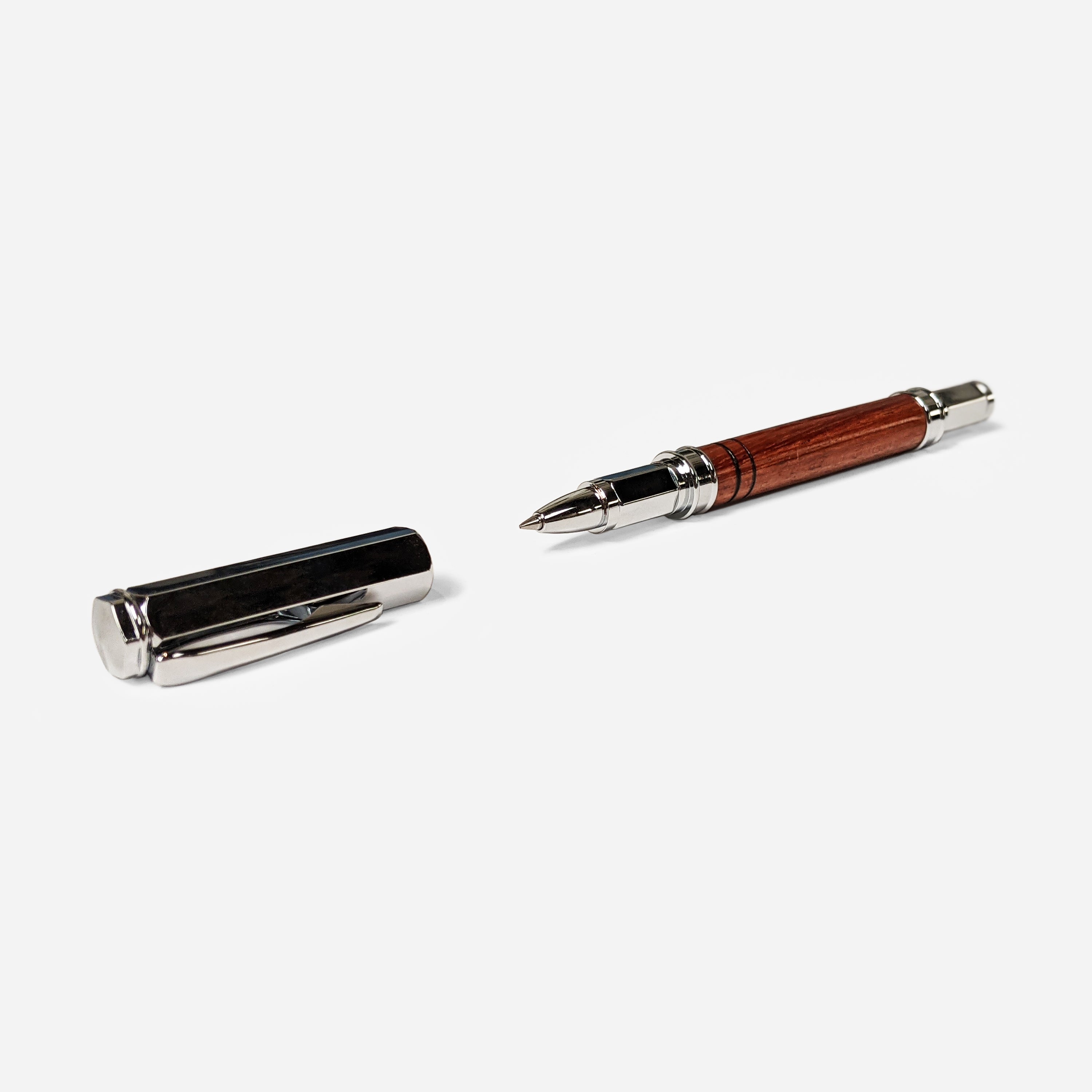 Vertex Rollerball Pen by Cris Wolf featuring a Bubinga wood body and magnetized cap, displayed in a velvet box.