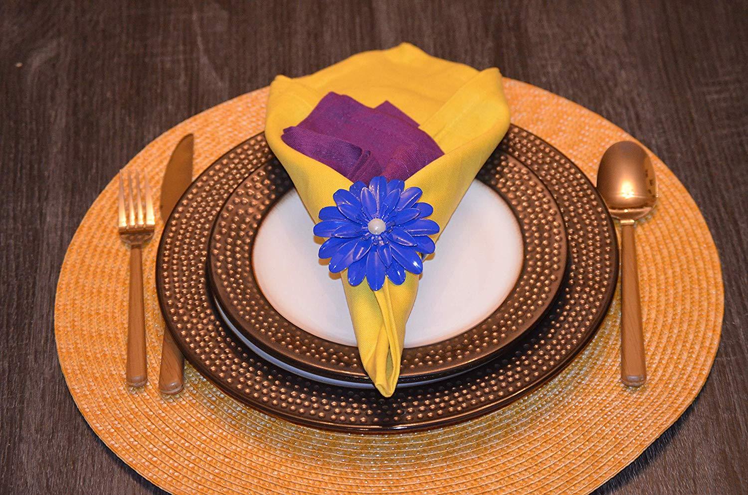 Set of 4 handcrafted blue floral napkin rings with pearl accents, perfect for elegant dining decor.