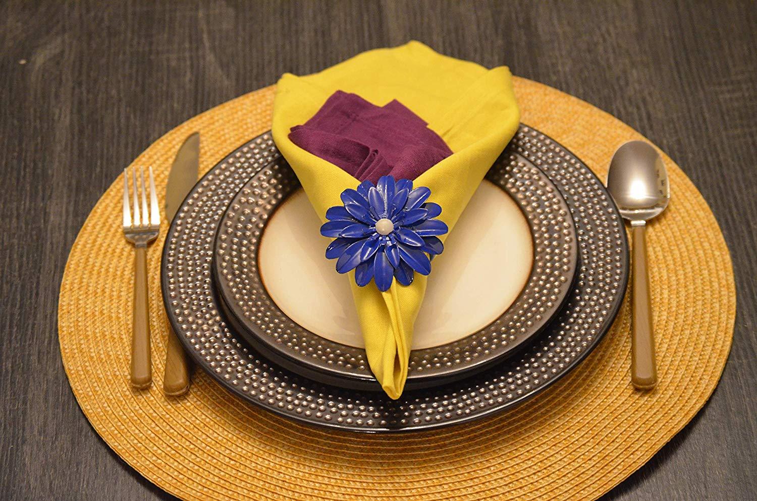 Set of 4 handcrafted blue floral napkin rings with pearl accents, perfect for elegant dining decor.