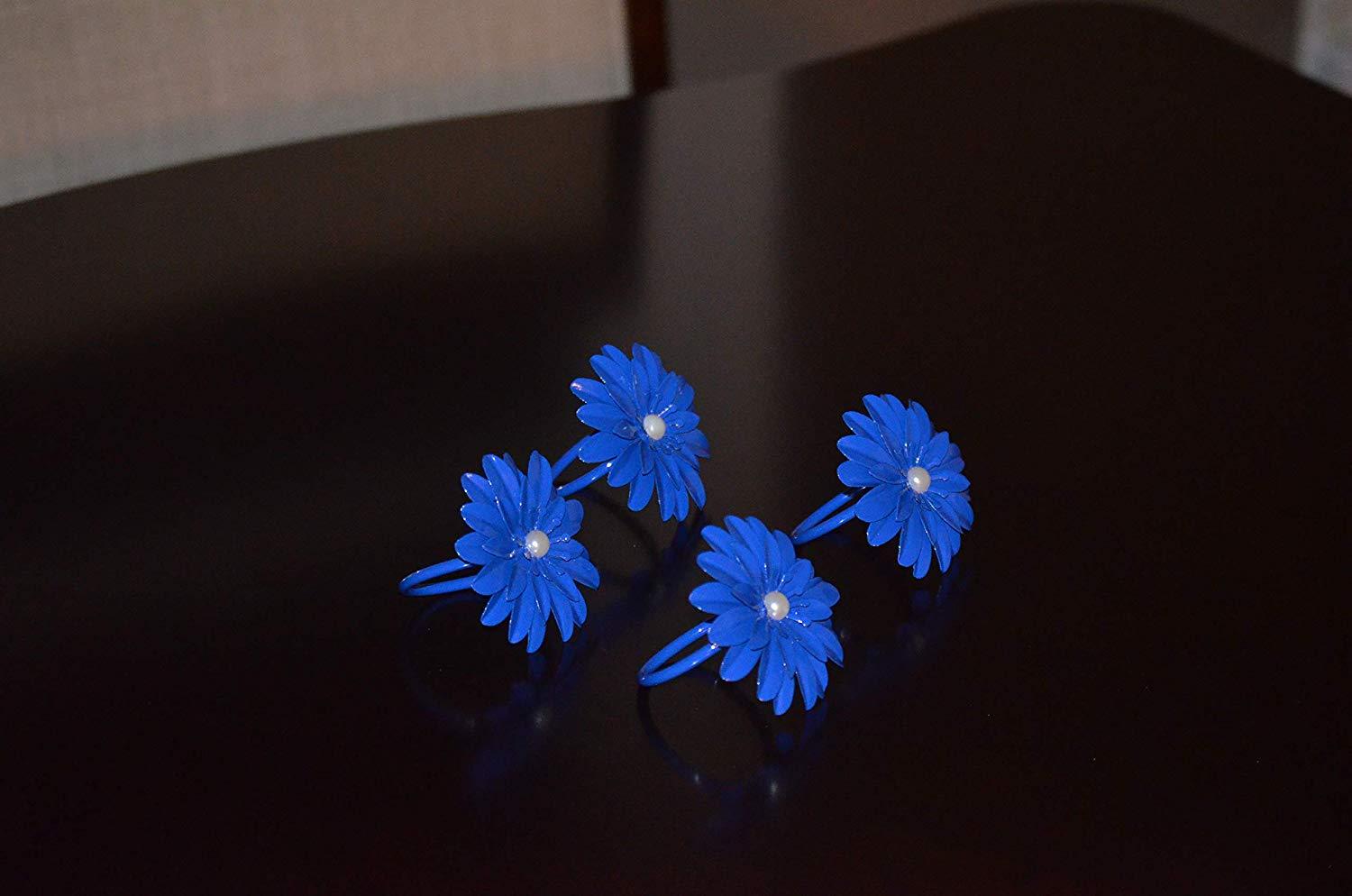 Set of 4 handcrafted blue floral napkin rings with pearl accents, perfect for elegant dining decor.