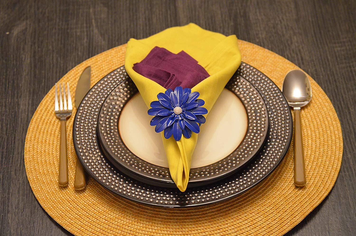 Set of 4 handcrafted blue floral napkin rings with pearl accents, perfect for elegant dining decor.