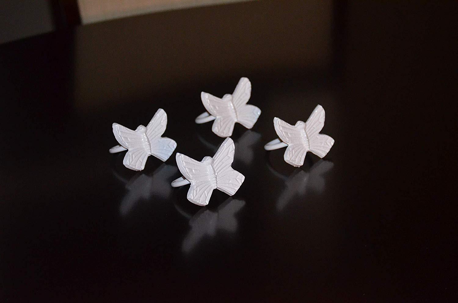 Set of 4 handcrafted aluminum butterfly napkin rings, elegantly designed for upscale dining decor.