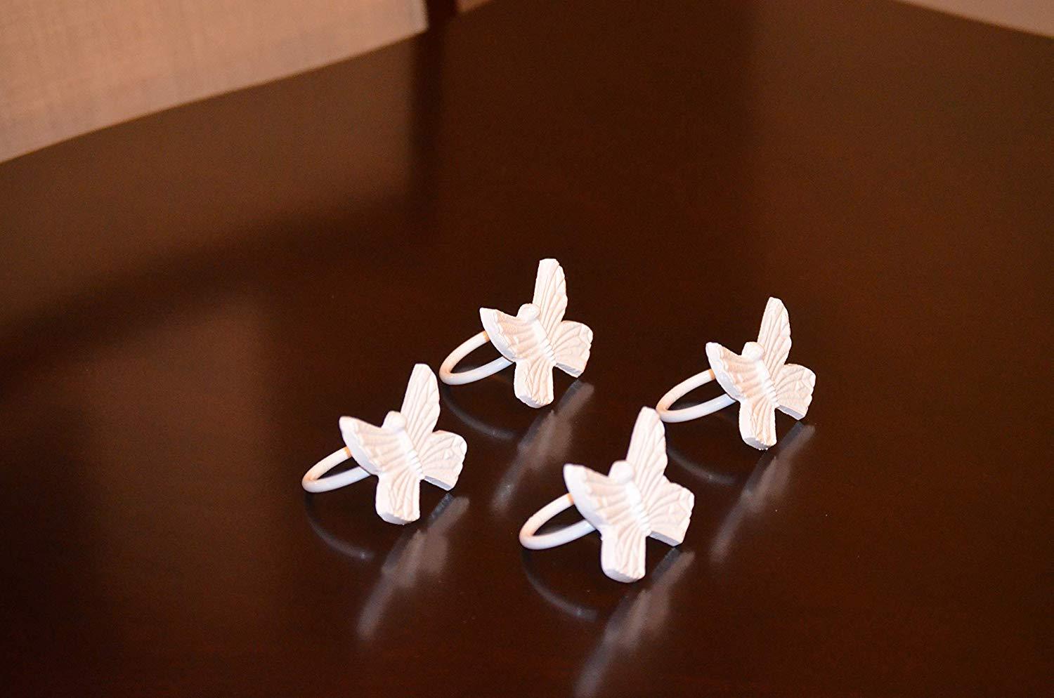 Set of 4 handcrafted aluminum butterfly napkin rings, elegantly designed for upscale dining decor.